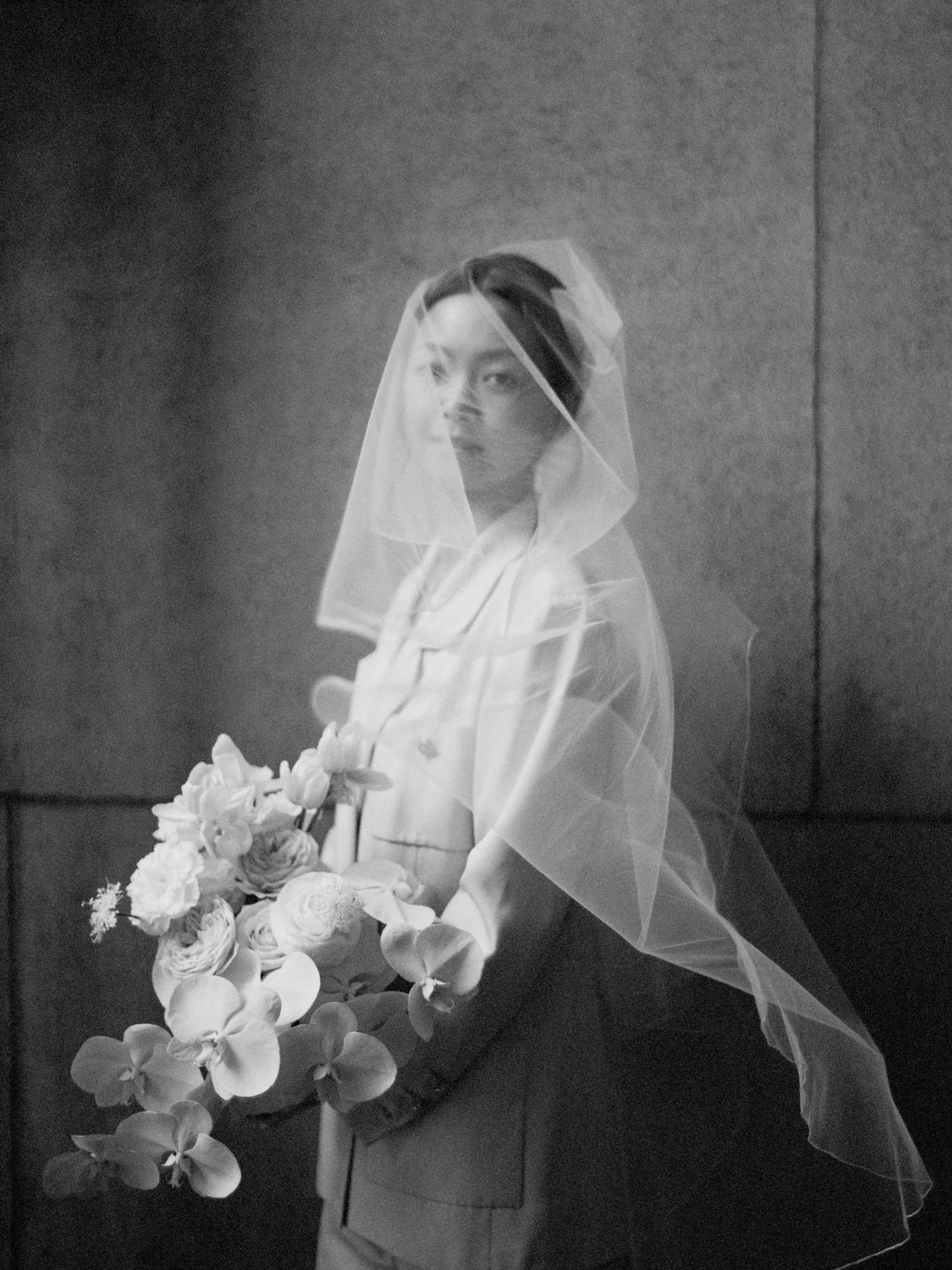 Modern bride in tailored white suit and veil during intimate Manhattan City Hall wedding