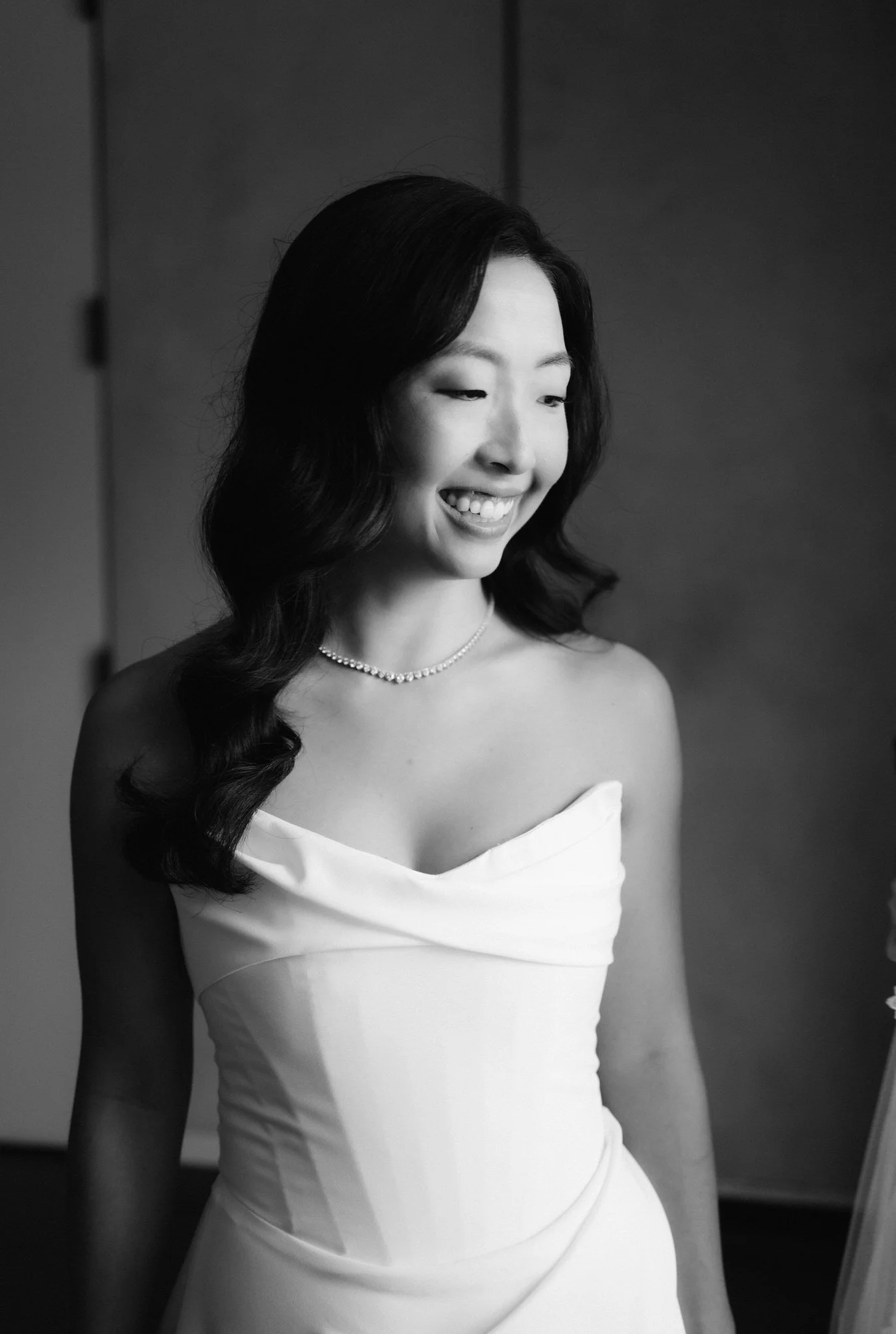 Black and white bridal portrait in a draped strapless gown with natural window light at Blue Hill at Stone Barns, photographed by Jenny Fu.