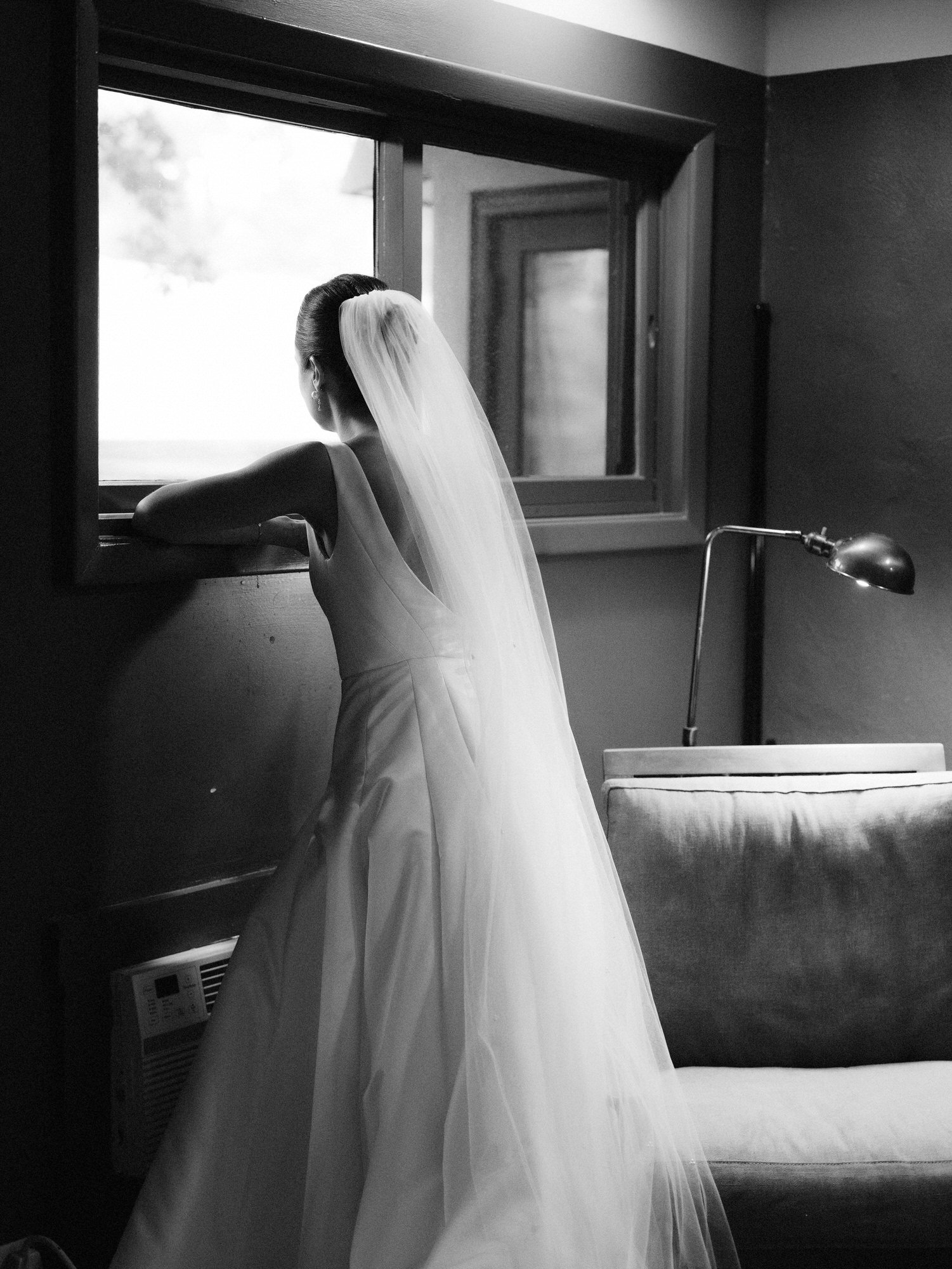 aa-0594-bride-looking-out-window-in-wedding-dress-troutbeck-amenia-ny-planned-by-ashley-douglass-jenny-fu.jpg