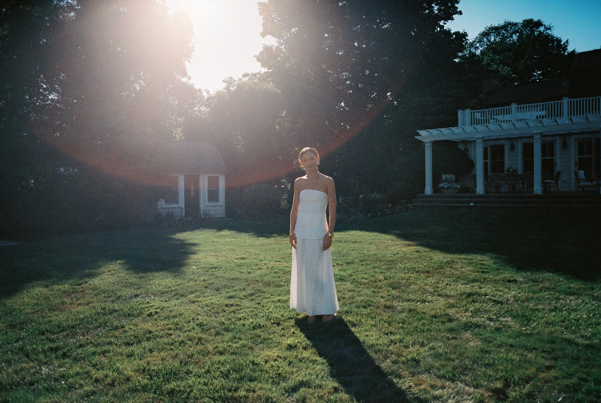 rb47-bride-standing-on-lawn-in-sunlight-with-lens-flare-new-jersey-jenny-fu.jpg