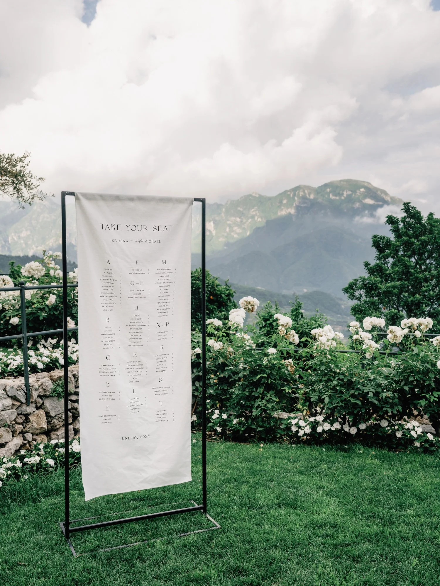 Minimalist seating chart display with mountain views and white florals at Caruso, A Belmond Hotel in Ravello, Italy, photographed by Jenny Fu.