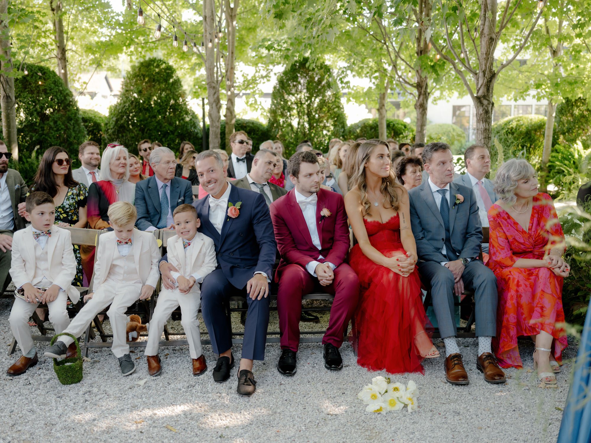 Guests seated beneath a canopy of maples, watching the ceremony at Valley Rock Inn in Sloatsburg, photographed by Jenny Fu.