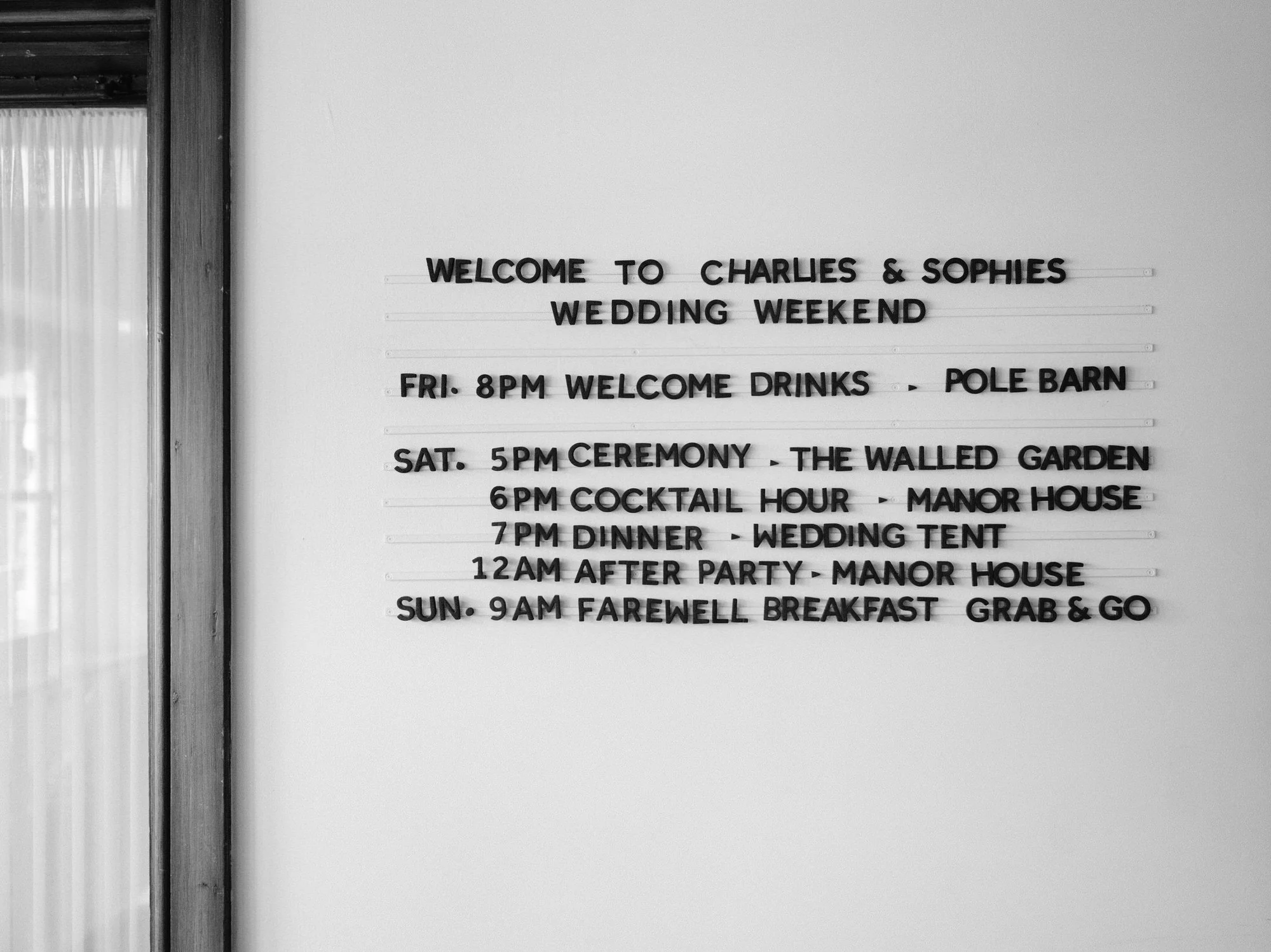 Black and white letterboard listing wedding weekend events for Charlie and Sophie at Troutbeck in Amenia, photographed by Jenny Fu.