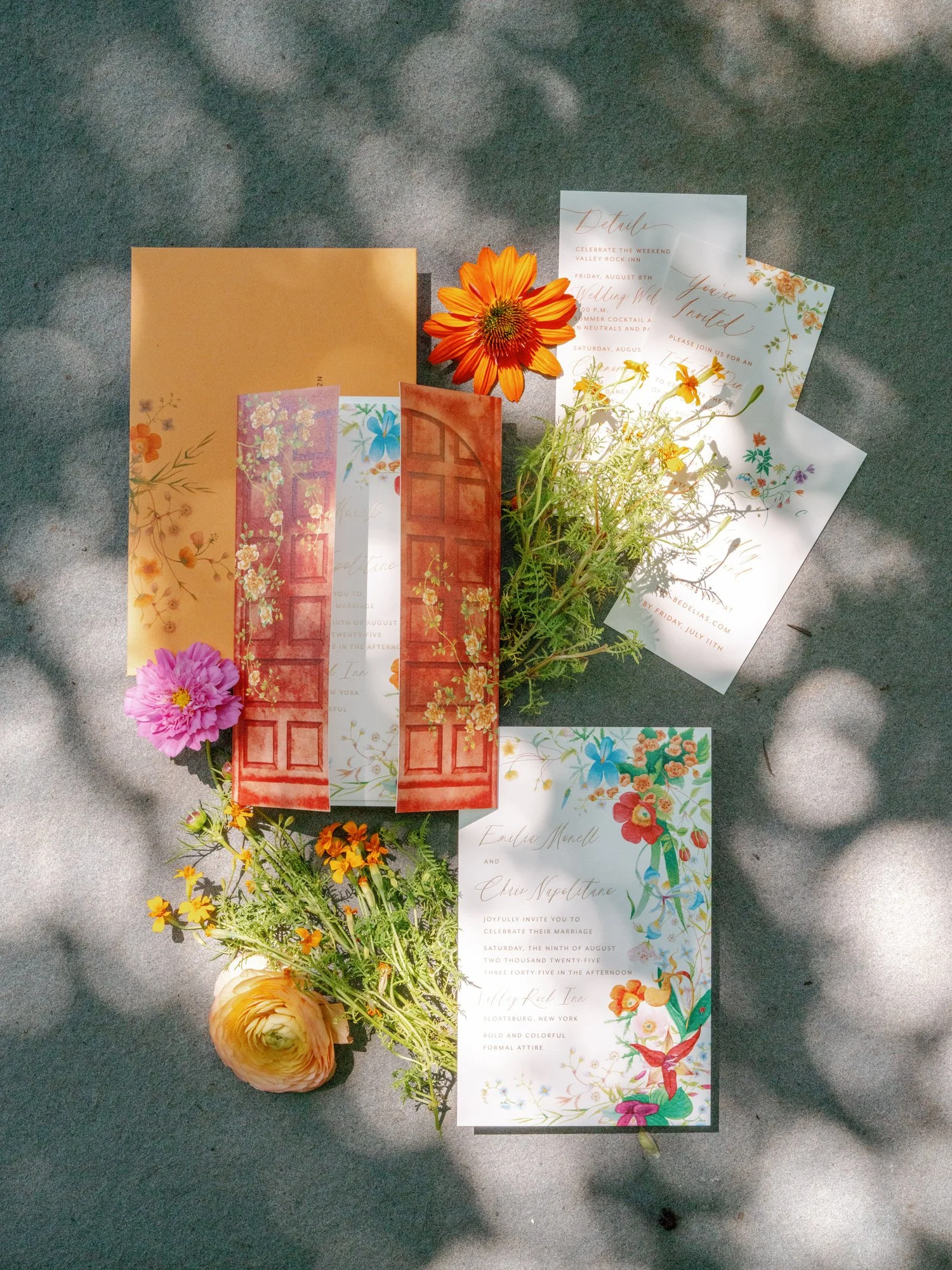Wedding invitation suite and wildflowers arranged in dappled light for a celebration at Valley Rock Inn in Sloatsburg, photographed by Jenny Fu.