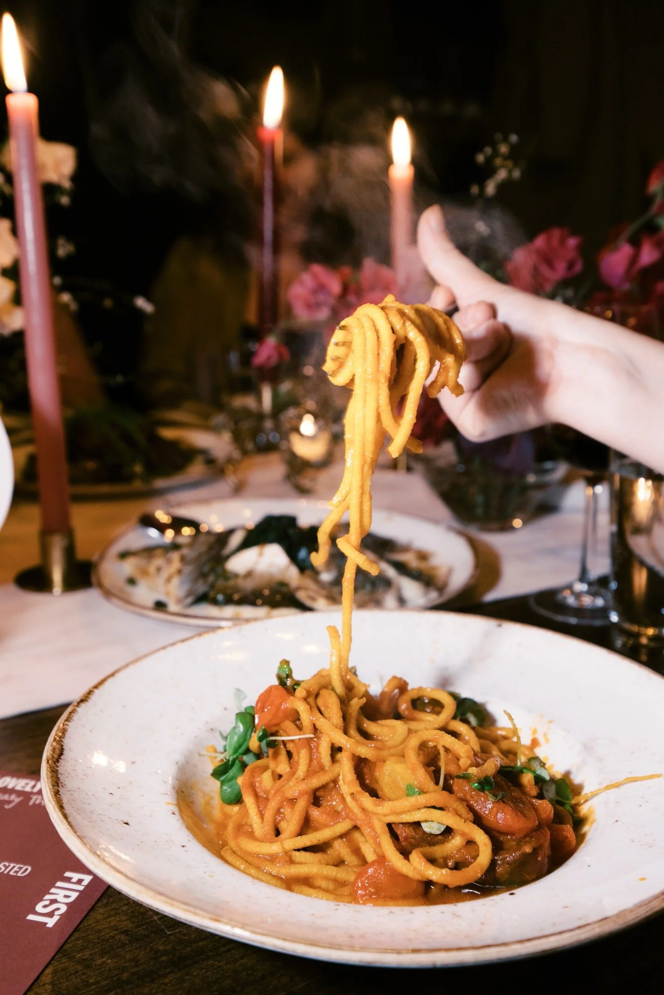 ald39-hand-twirling-fresh-pasta-over-candlelit-dinner-table-the-bowery-nyc-jenny-fu.jpg