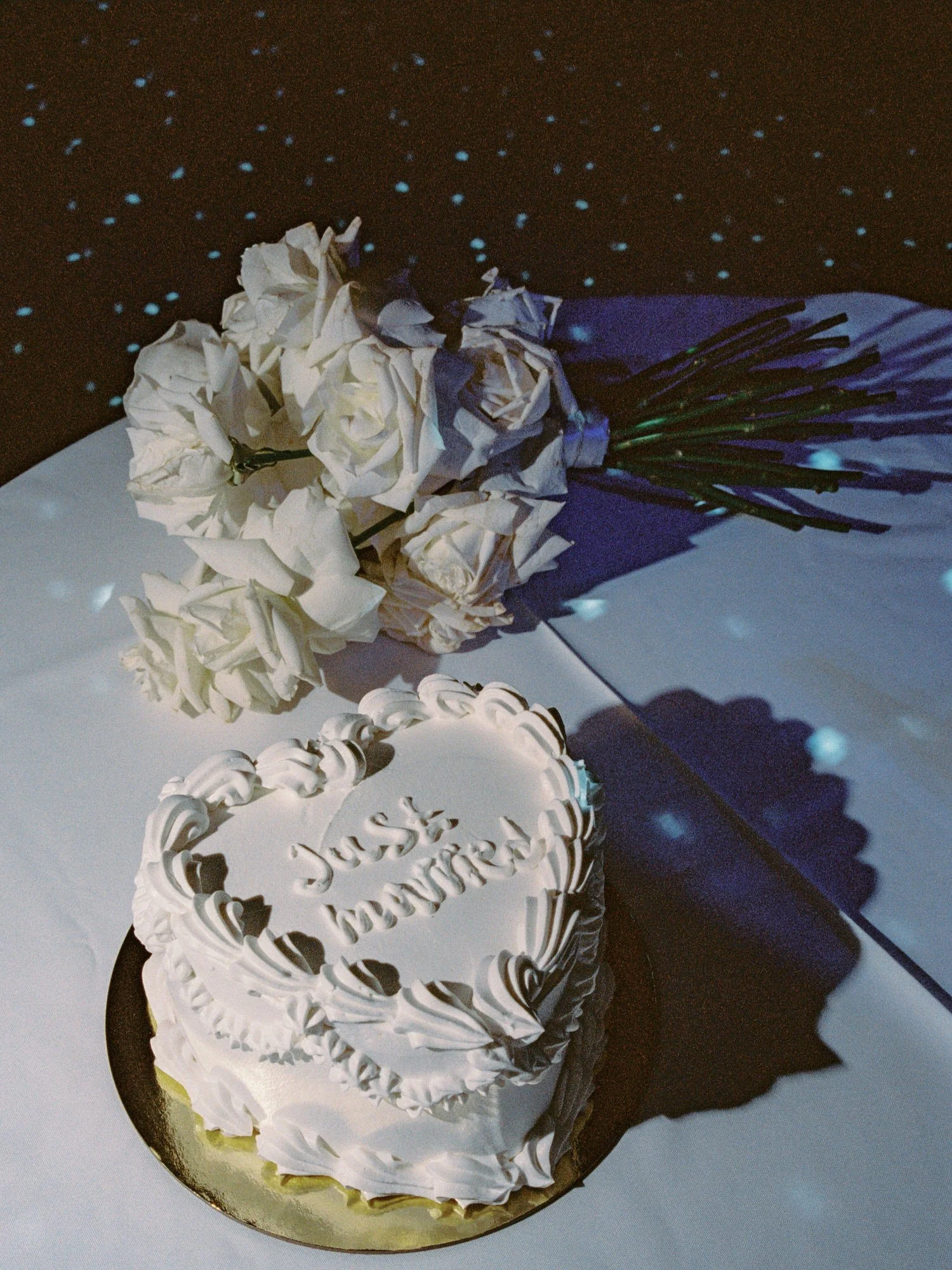 lp01-just-married-cake-and-white-rose-bouquet-on-table-destination-wedding-jenny-fu.jpg