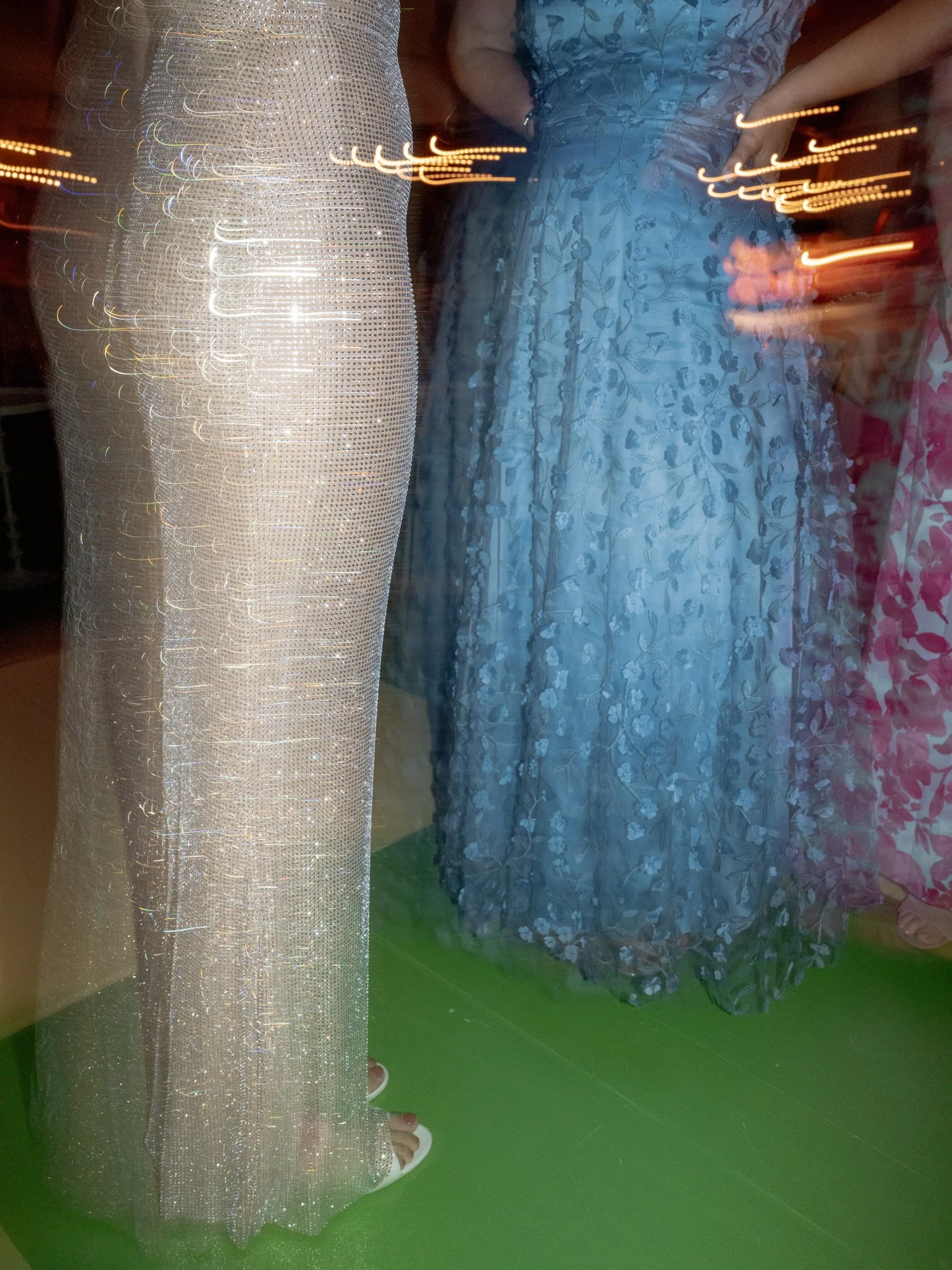 Close-up of shimmering silver and blue gowns catching light on the dance floor at Valley Rock Inn in Sloatsburg, photographed by Jenny Fu.