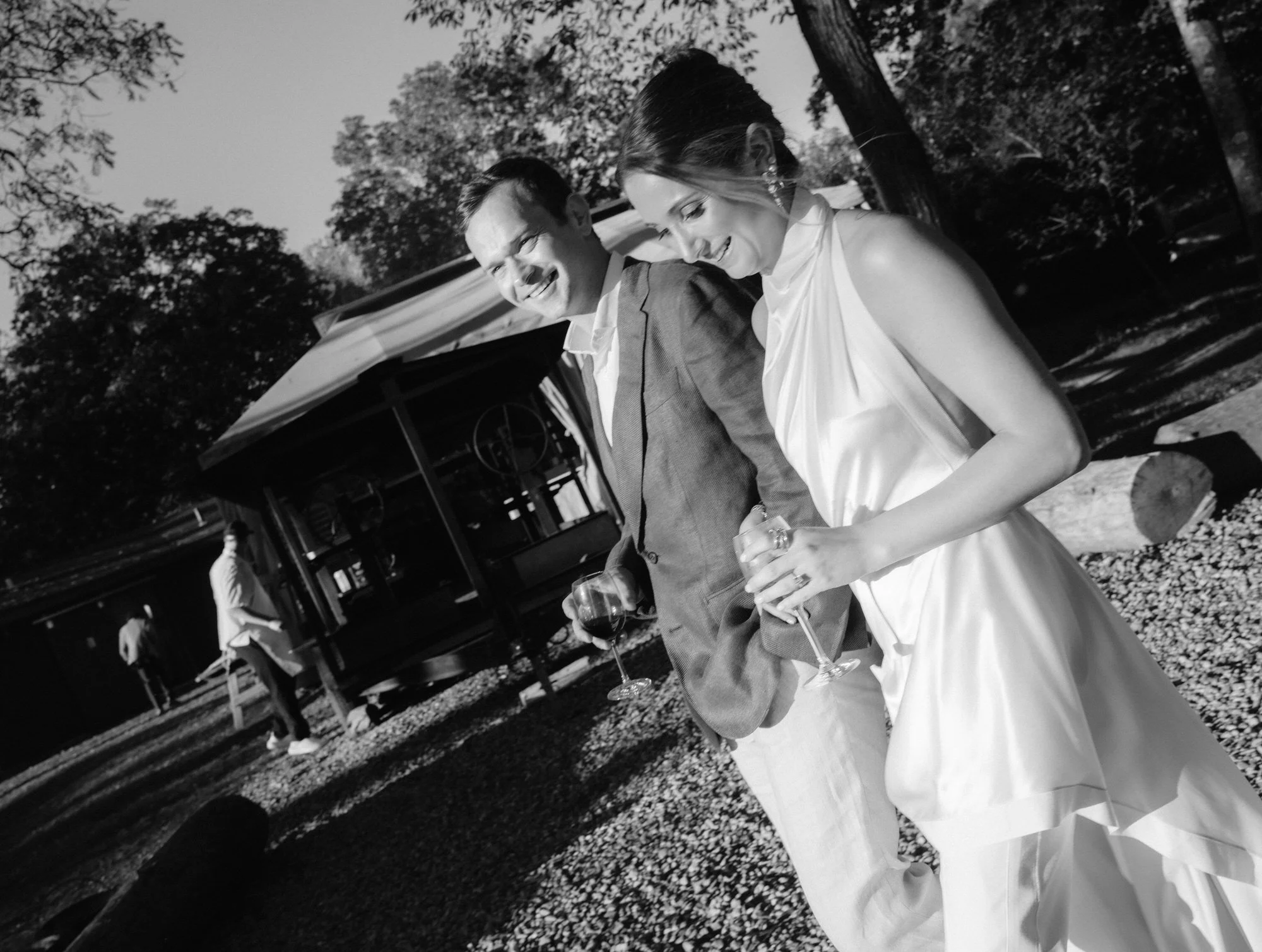 Candid moment of the couple laughing while walking past guests outside Troutbeck in Amenia, photographed by Jenny Fu.