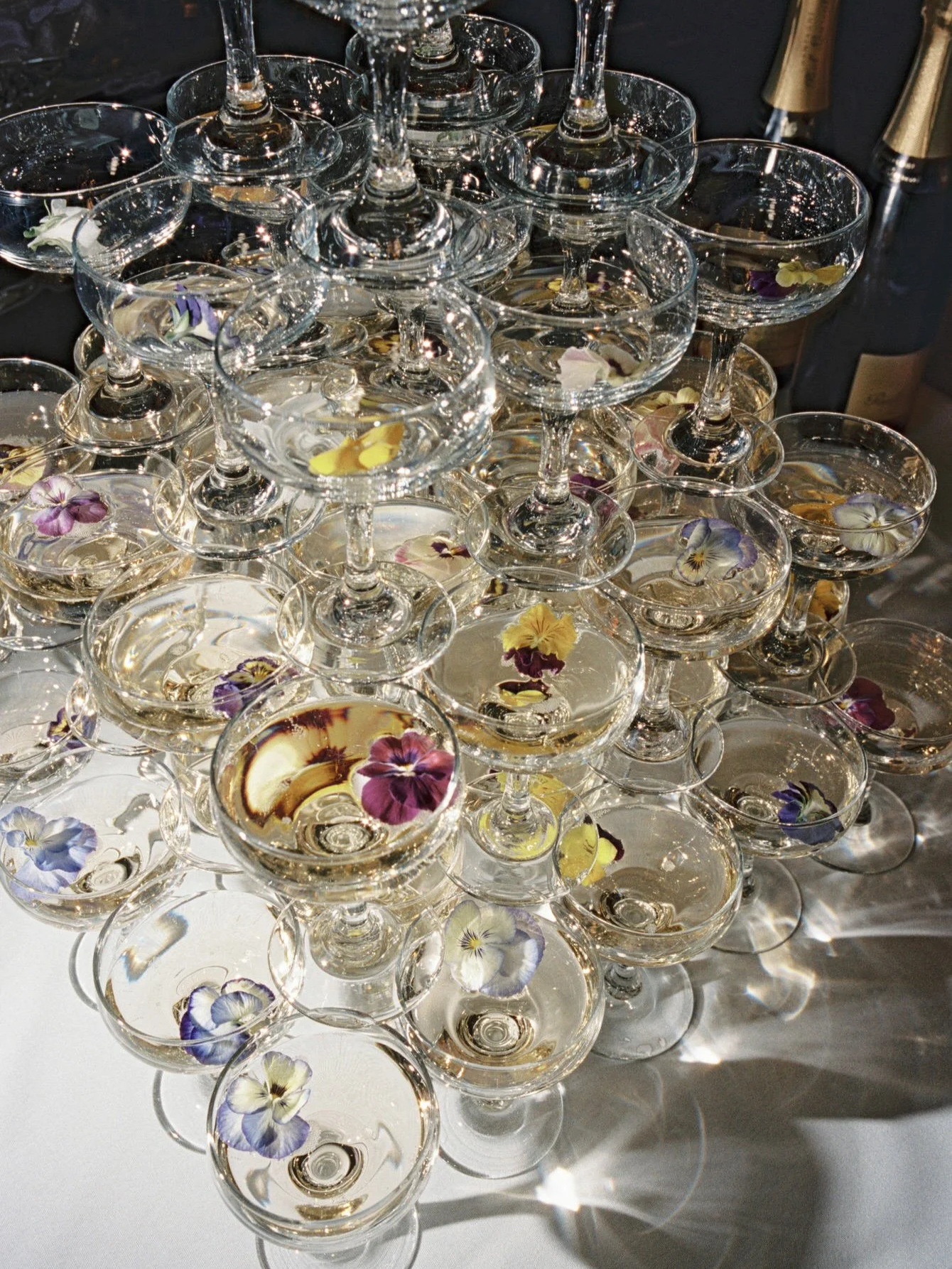 Champagne tower with coupe glasses and edible flowers at Valley Rock Inn, photographed by Jenny Fu.