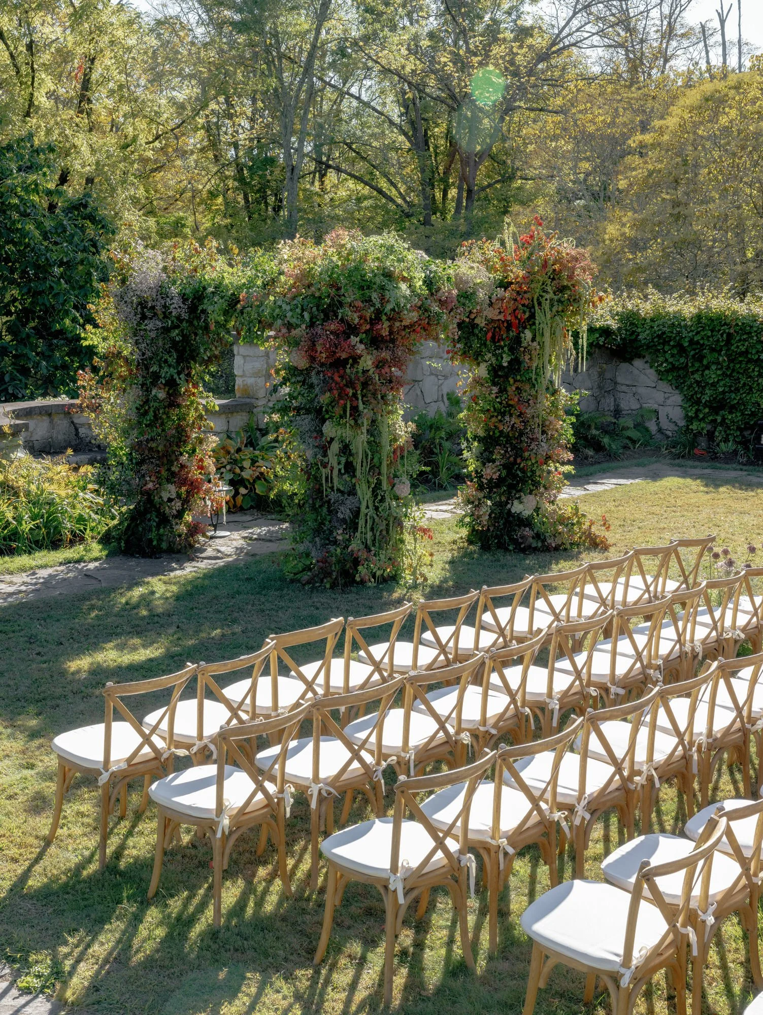 Side angle showing the garden ceremony altar and elegant seating layout at Troutbeck in Amenia, photographed by Jenny Fu.