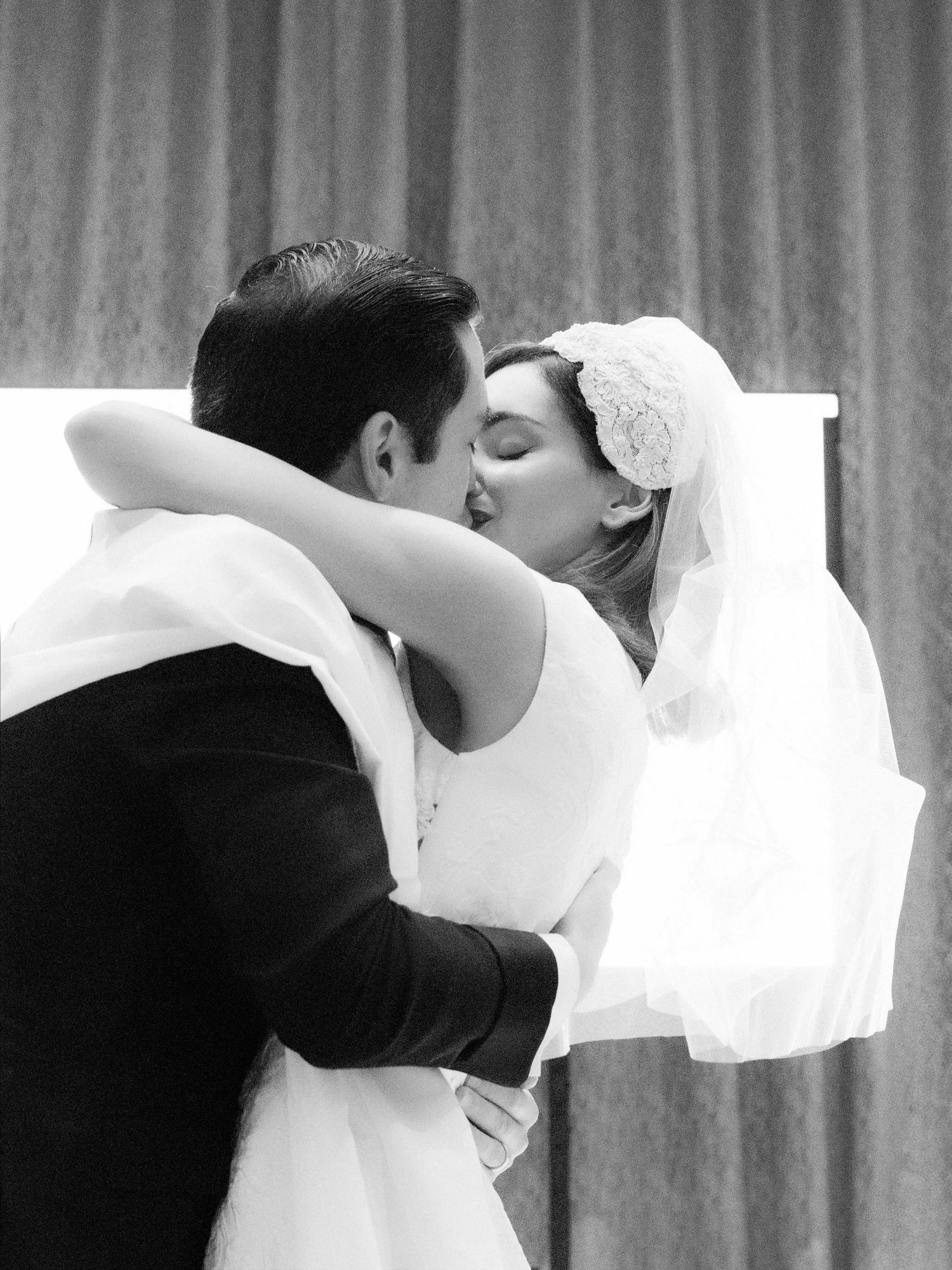 Black and white close-up of the bride and groom kissing at their Waldorf Astoria New York wedding, photographed by Jenny Fu.