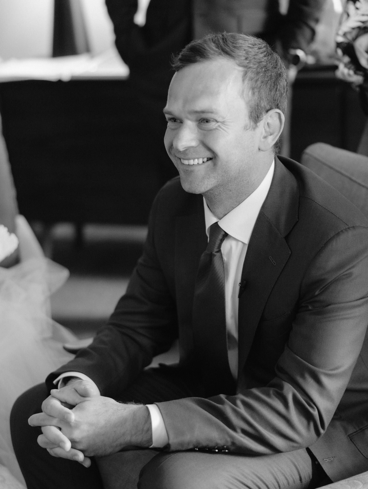Groom smiling in a tailored suit during getting ready moments at Troutbeck in Amenia, photographed by Jenny Fu.