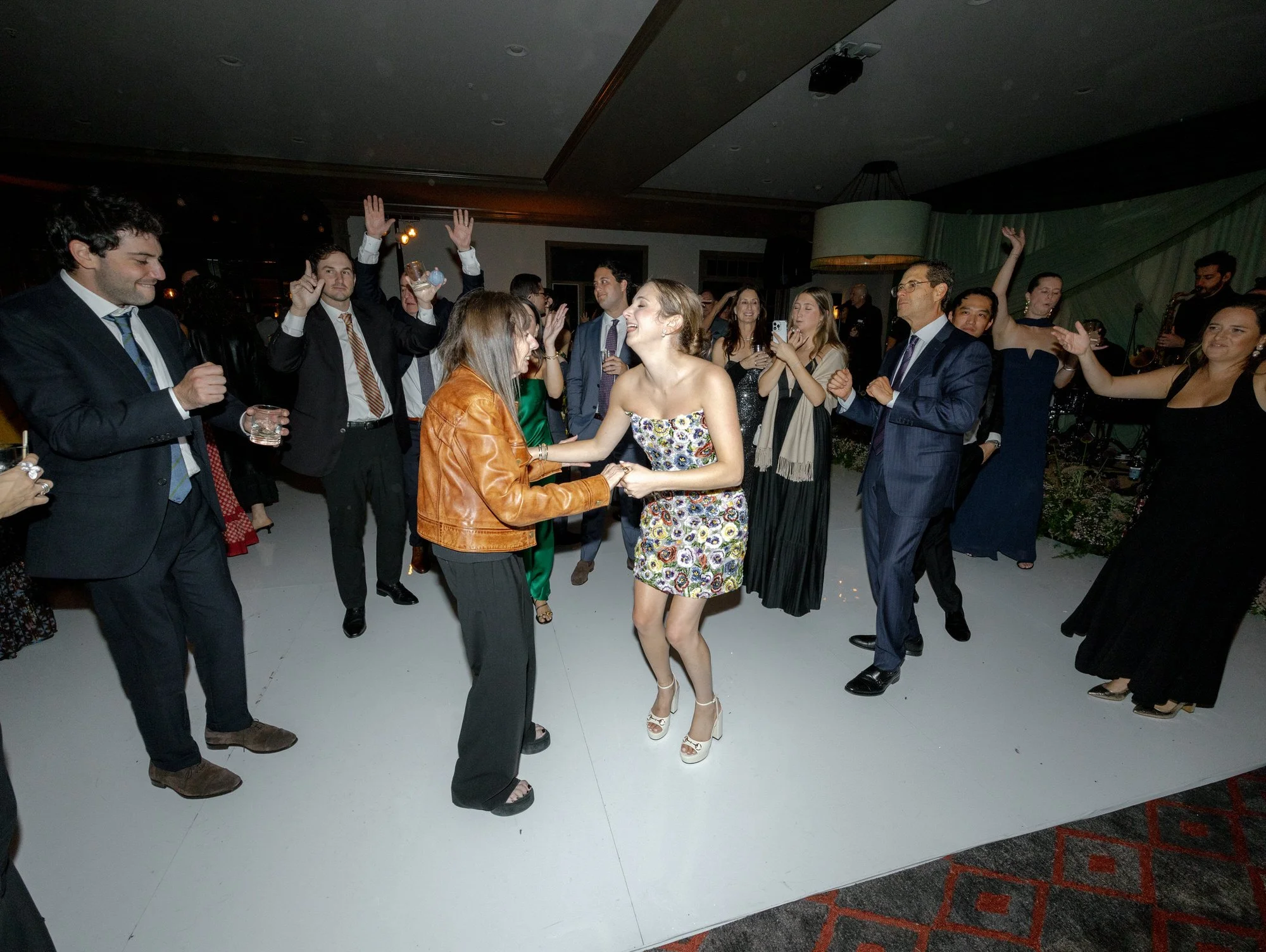Guests celebrating on the dance floor during the lively reception at Troutbeck in Amenia, photographed by Jenny Fu.
