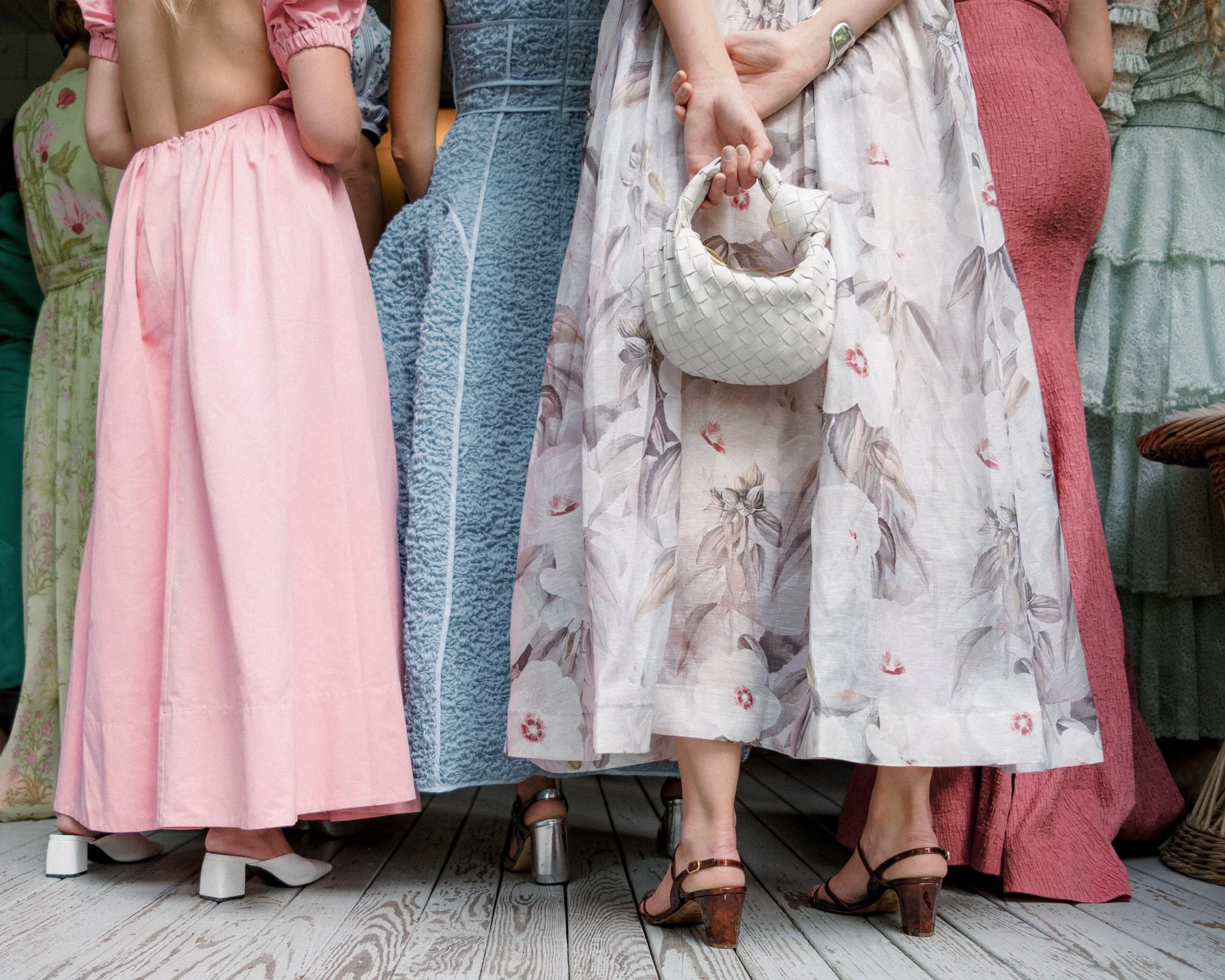 Wedding guests in vibrant colorful dresses gathered at The Ausable Club in the Adirondack Mountains