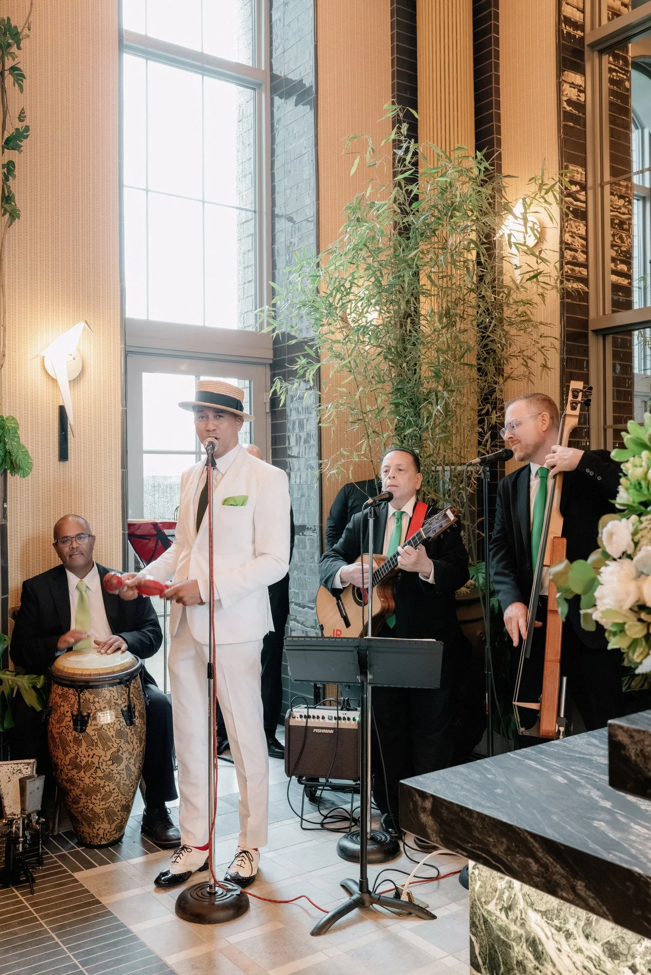 Live band with congas, guitar and upright bass playing at a Waldorf Astoria New York wedding reception, photographed by Jenny Fu.