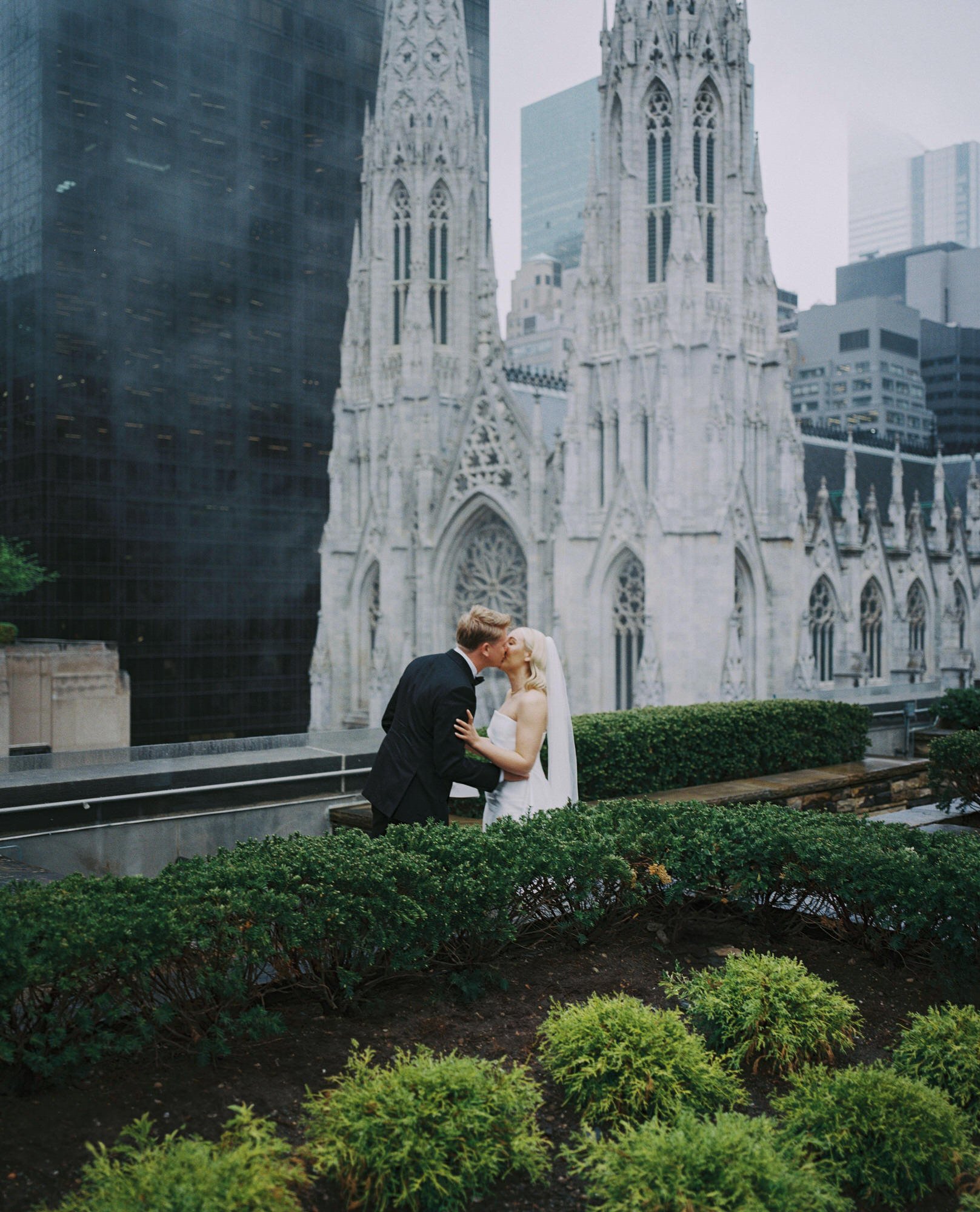 KD-film-005-bride-and-groom-kiss-on-terrace-overlooking-cathedral-620-loft-and-garden-jenny-fu.jpg
