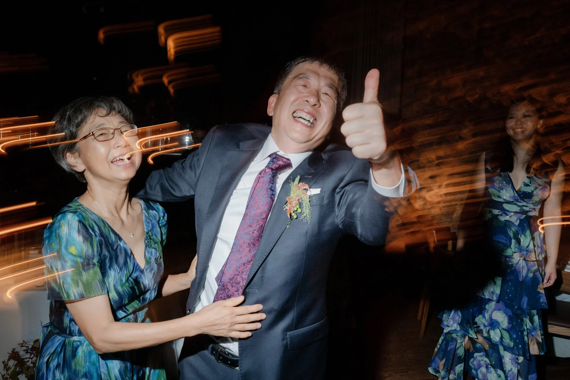 Family members dancing with joyful motion blur on the dance floor at Blue Hill at Stone Barns, photographed by Jenny Fu.
