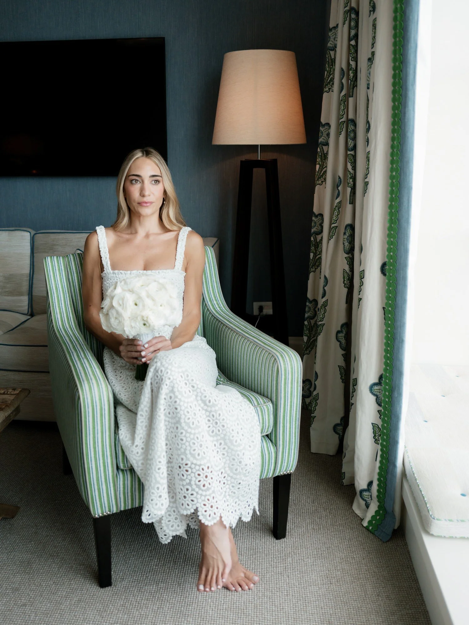 Bride seated gracefully by the window in her lace gown, bouquet in hand, at Crosby Street Hotel in Soho, photographed by Jenny Fu.