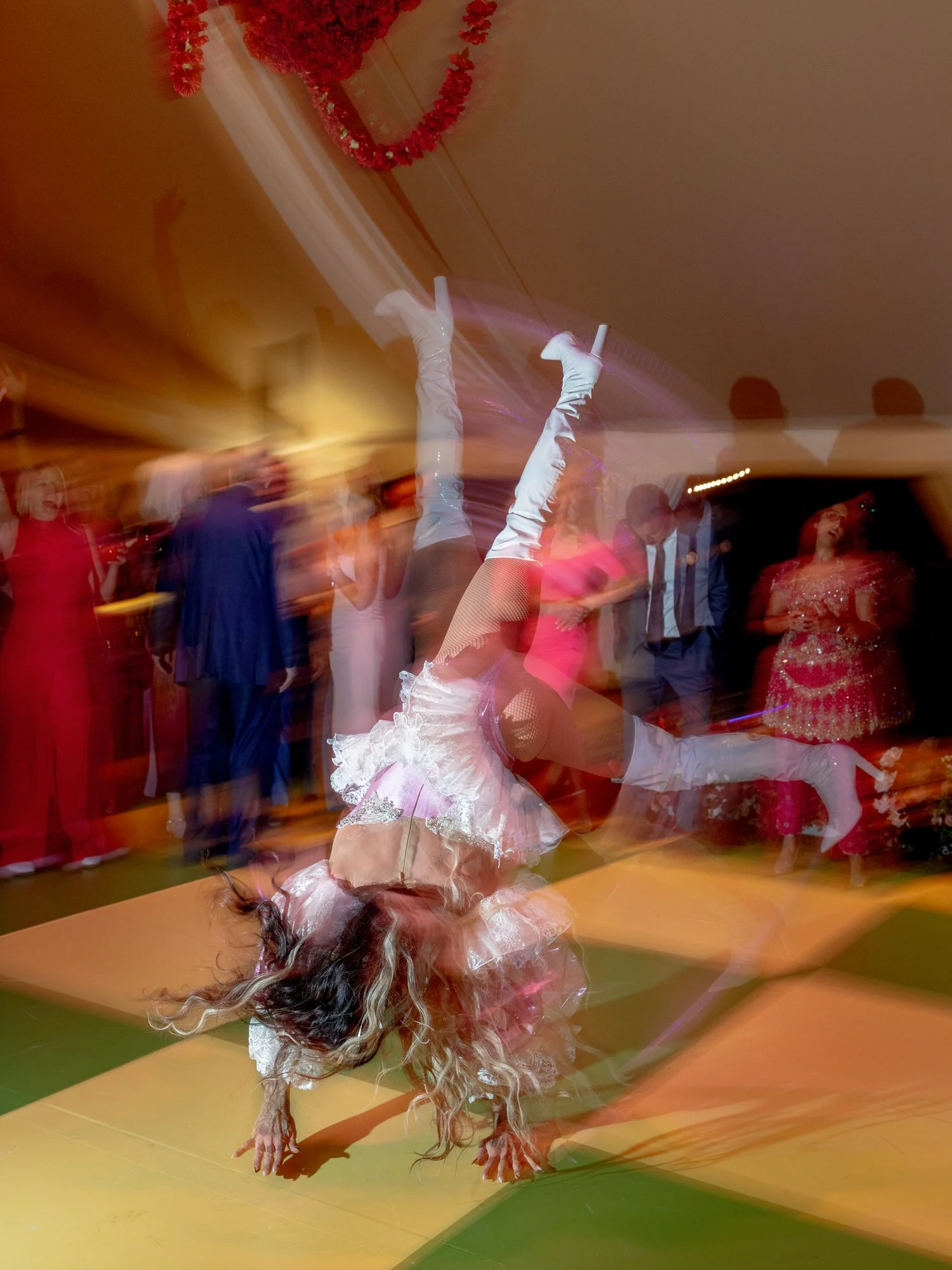 Drag queen performer in white boots captured mid-dance on the green and yellow checkered floor at Valley Rock Inn in Sloatsburg, photographed by Jenny Fu.