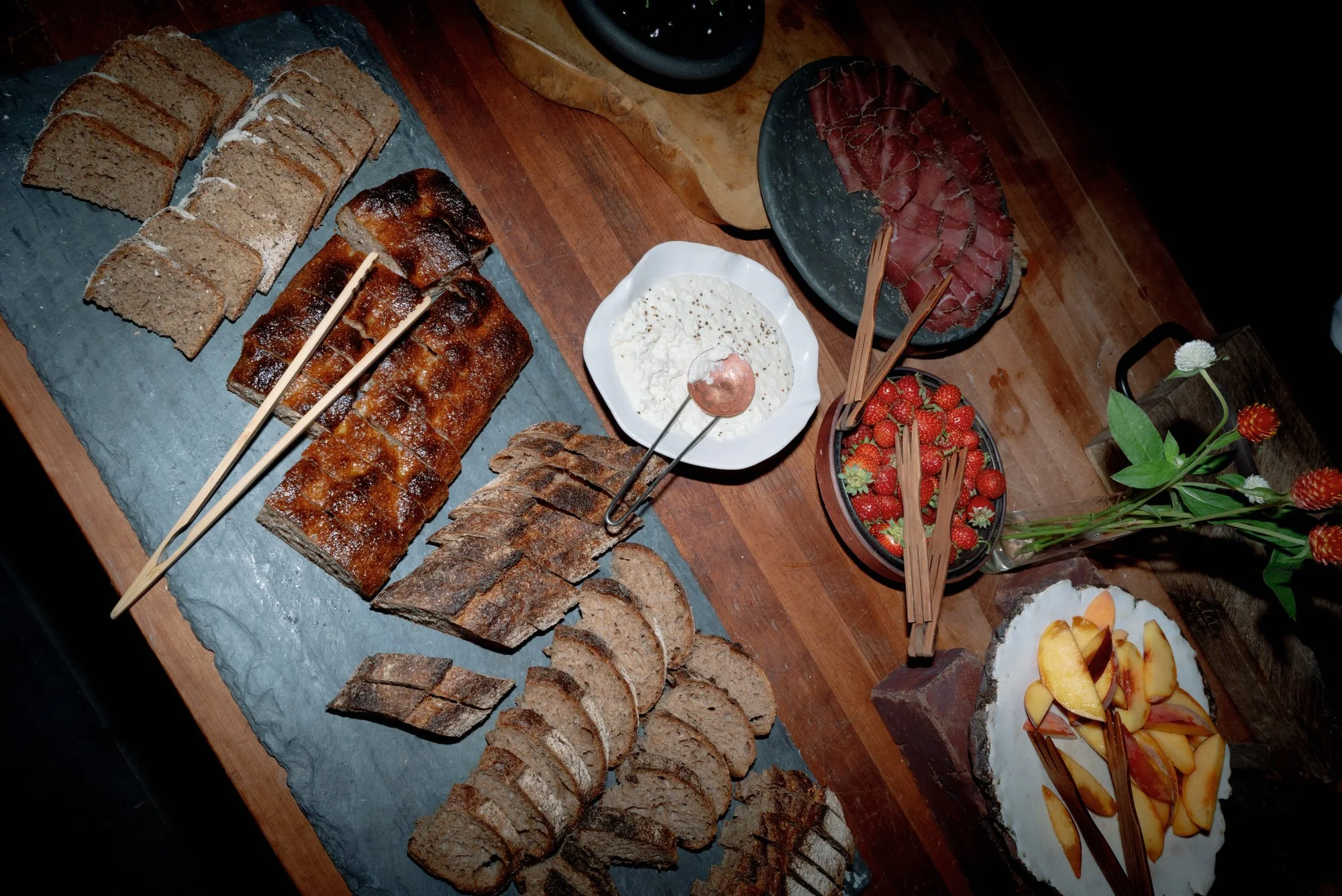Farm-to-table spread of breads, fruit, and housemade dips arranged for cocktail hour at Blue Hill at Stone Barns, photographed by Jenny Fu.
