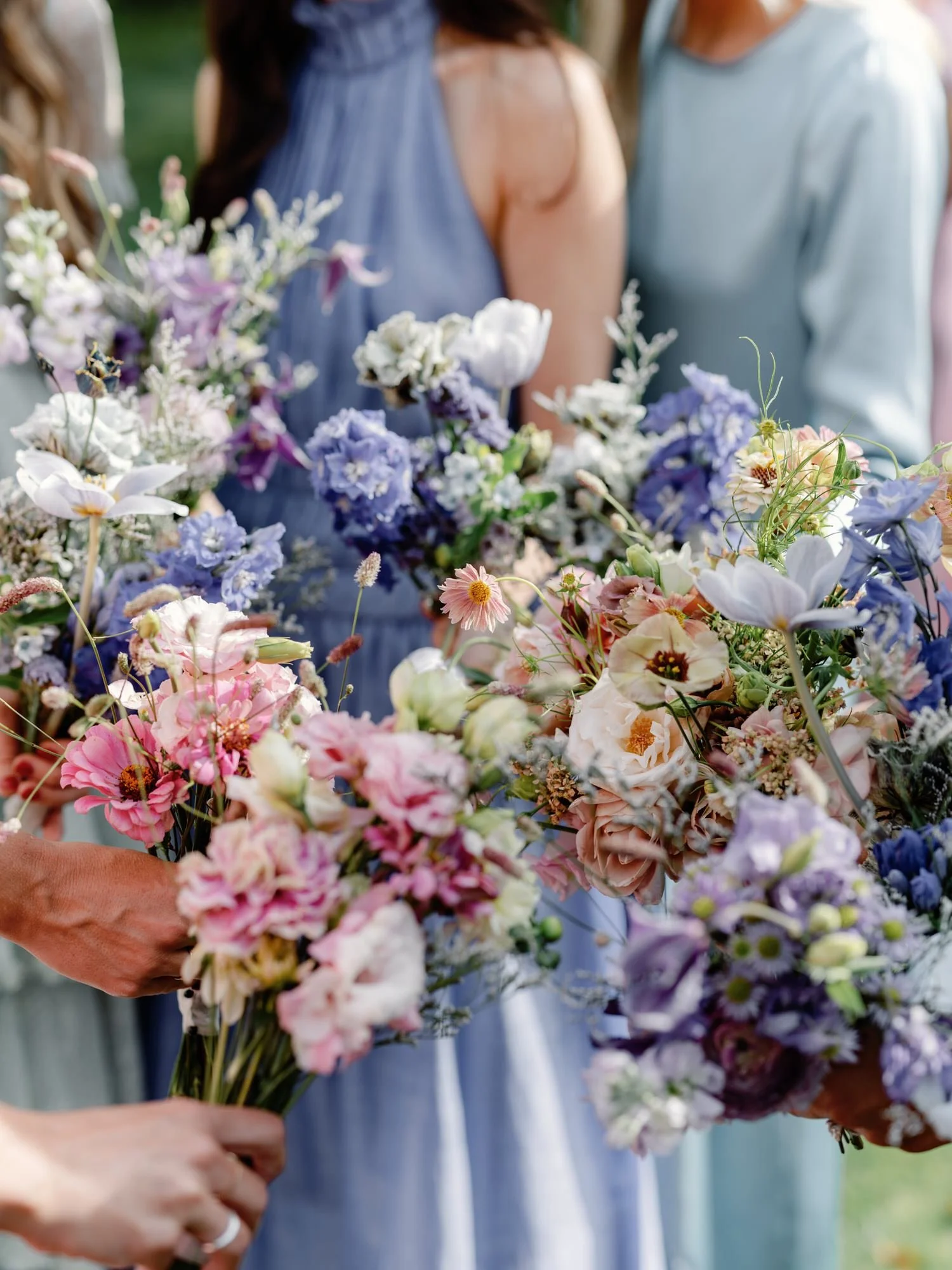 Close-up of colorful bridesmaid bouquets with pink, purple, and white florals at the Ausable Club in the Adirondacks