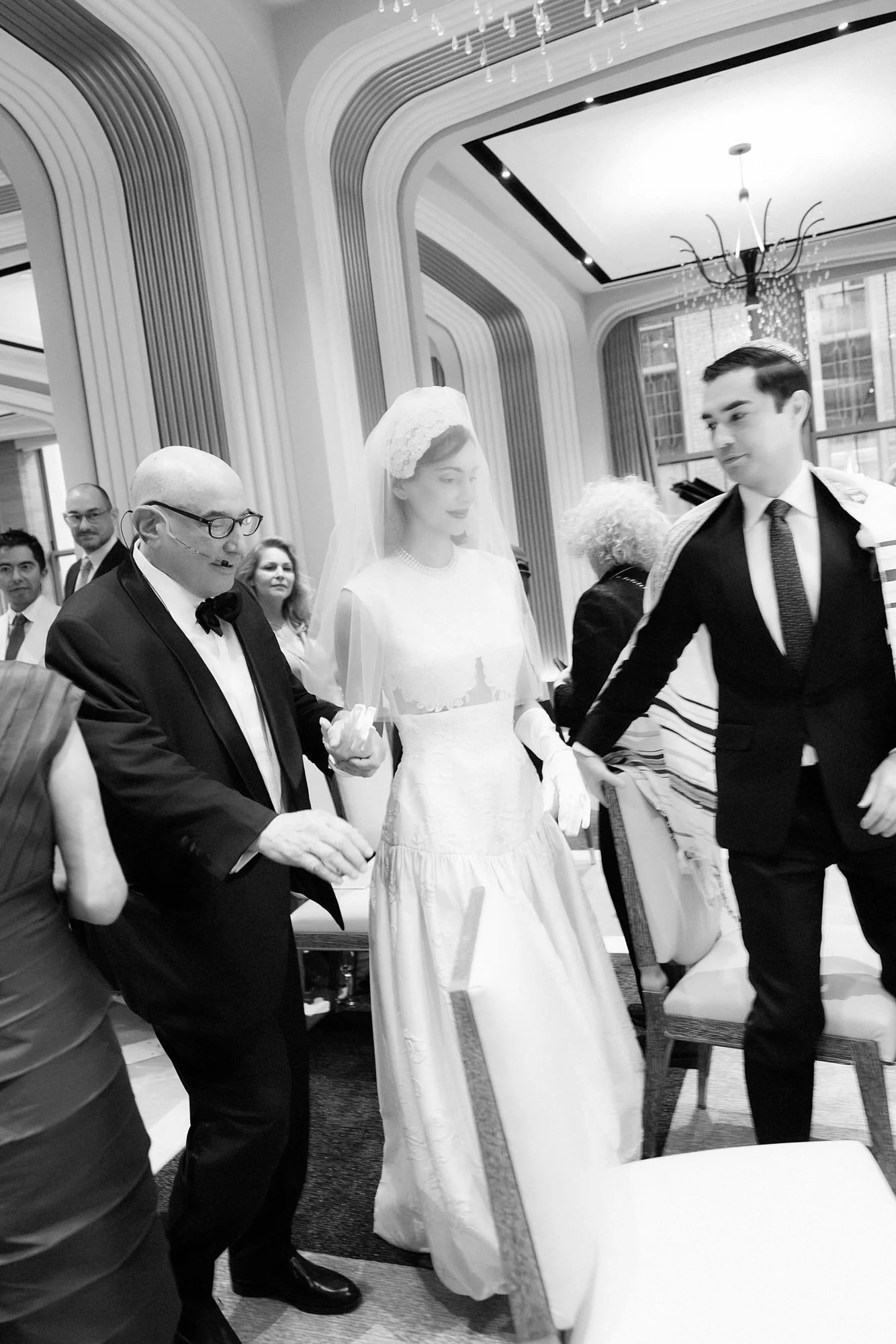 Black and white photo of the bride and groom celebrating with family on the dance floor at their Waldorf Astoria New York wedding, photographed by Jenny Fu.