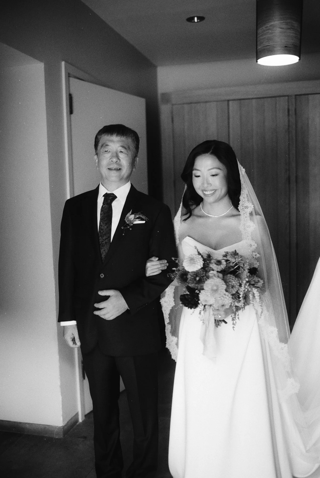 Bride with her father waiting to enter the ceremony in black and white at Blue Hill at Stone Barns, photographed by Jenny Fu.