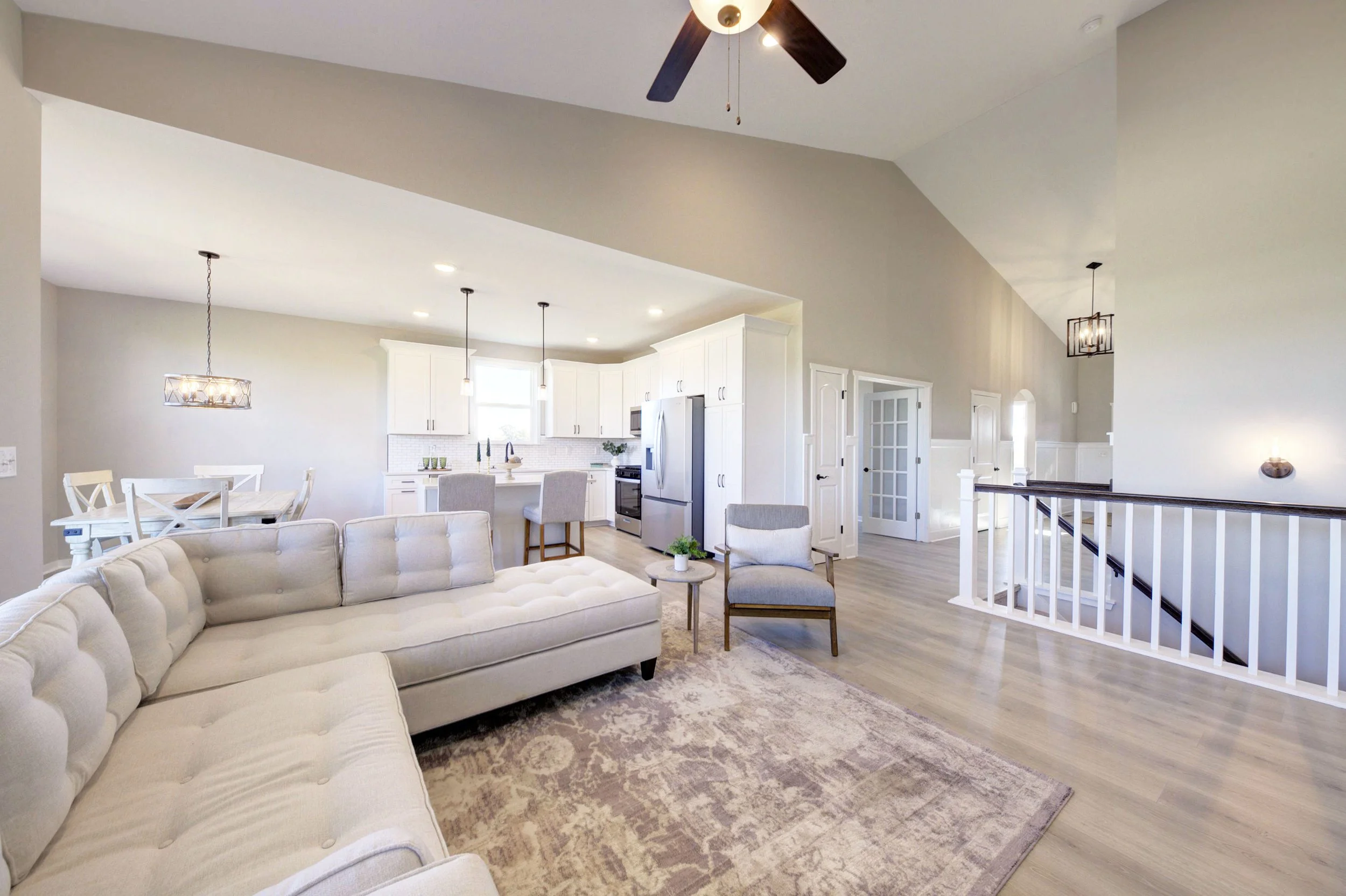 Stylish ranch condo in howell mi, with green grass, gray stone, gray siding, garage, sidewalk