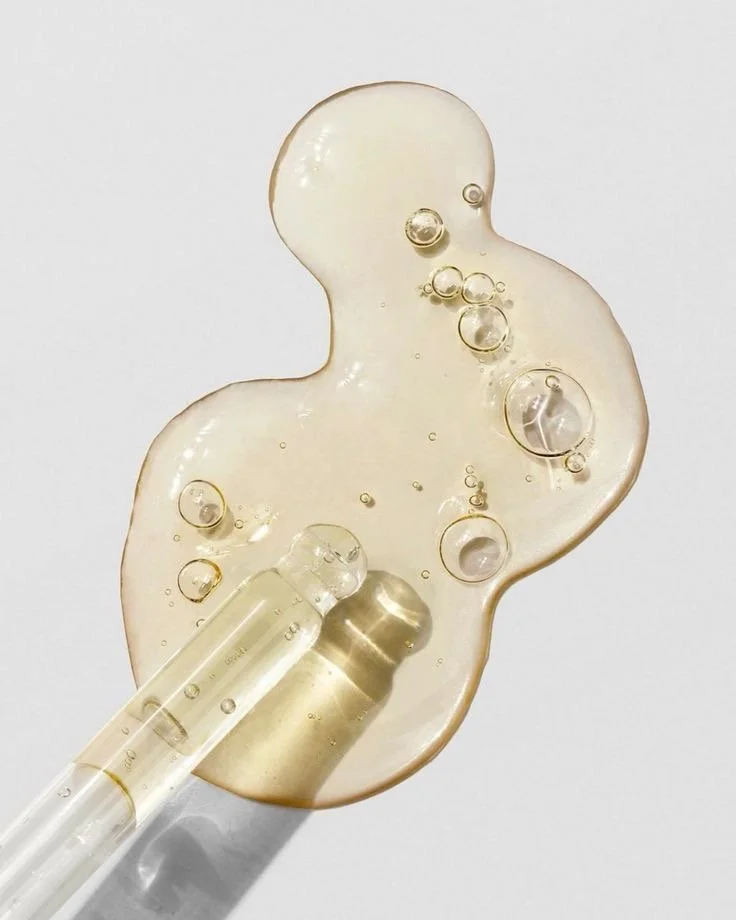 A clear gel with bubbles, resembling hand sanitizer or soap, with a small test tube or vial placed on top.