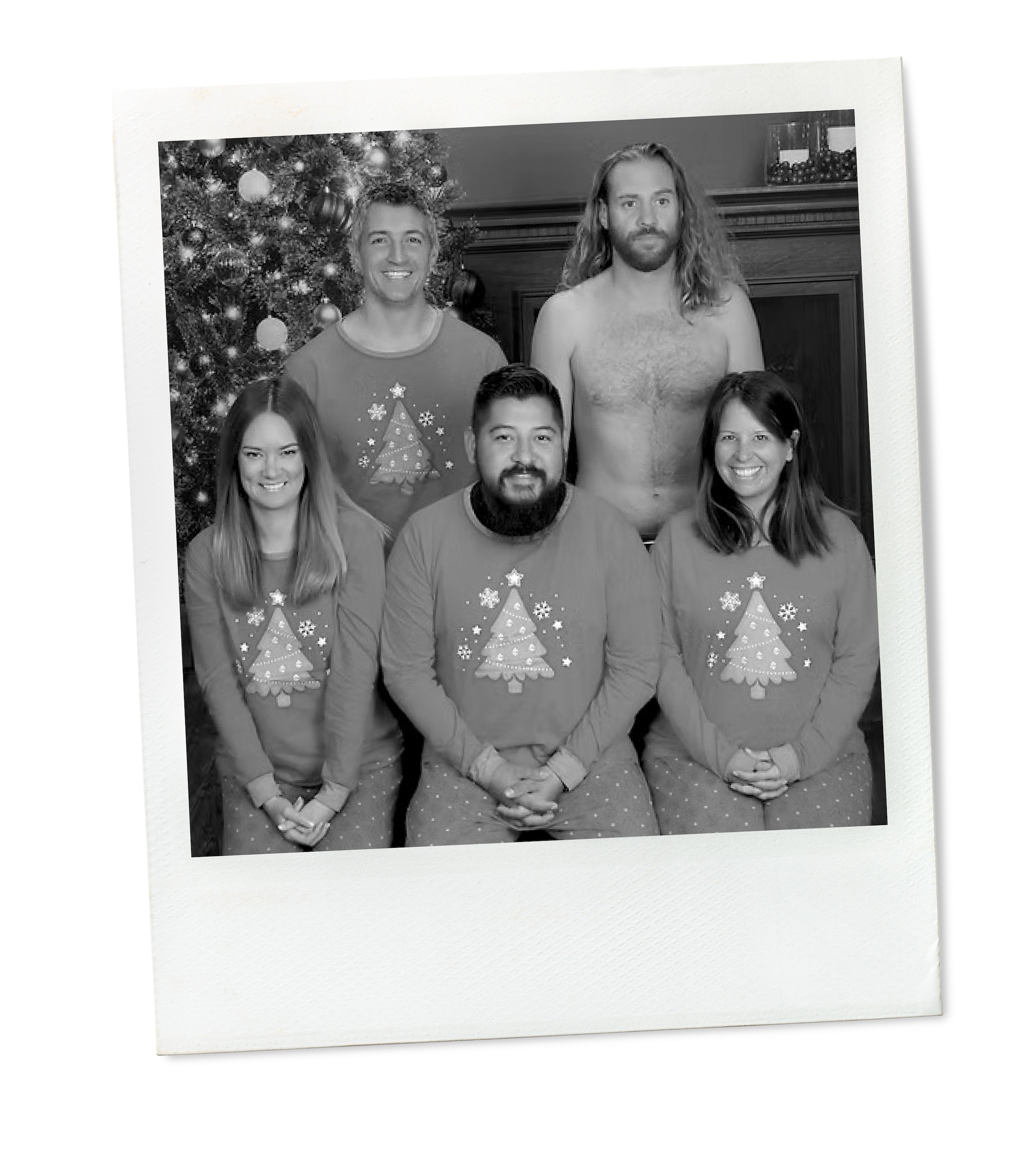 Black and white photograph of Tosti Design team, all wearing holiday-themed pajamas with a Christmas tree design, posing in front of a decorated Christmas tree.