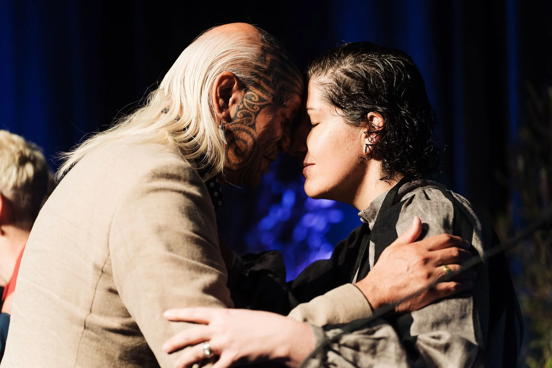 Conference attendees sharing a traditional Māori hongi during the conference opening ceremony.