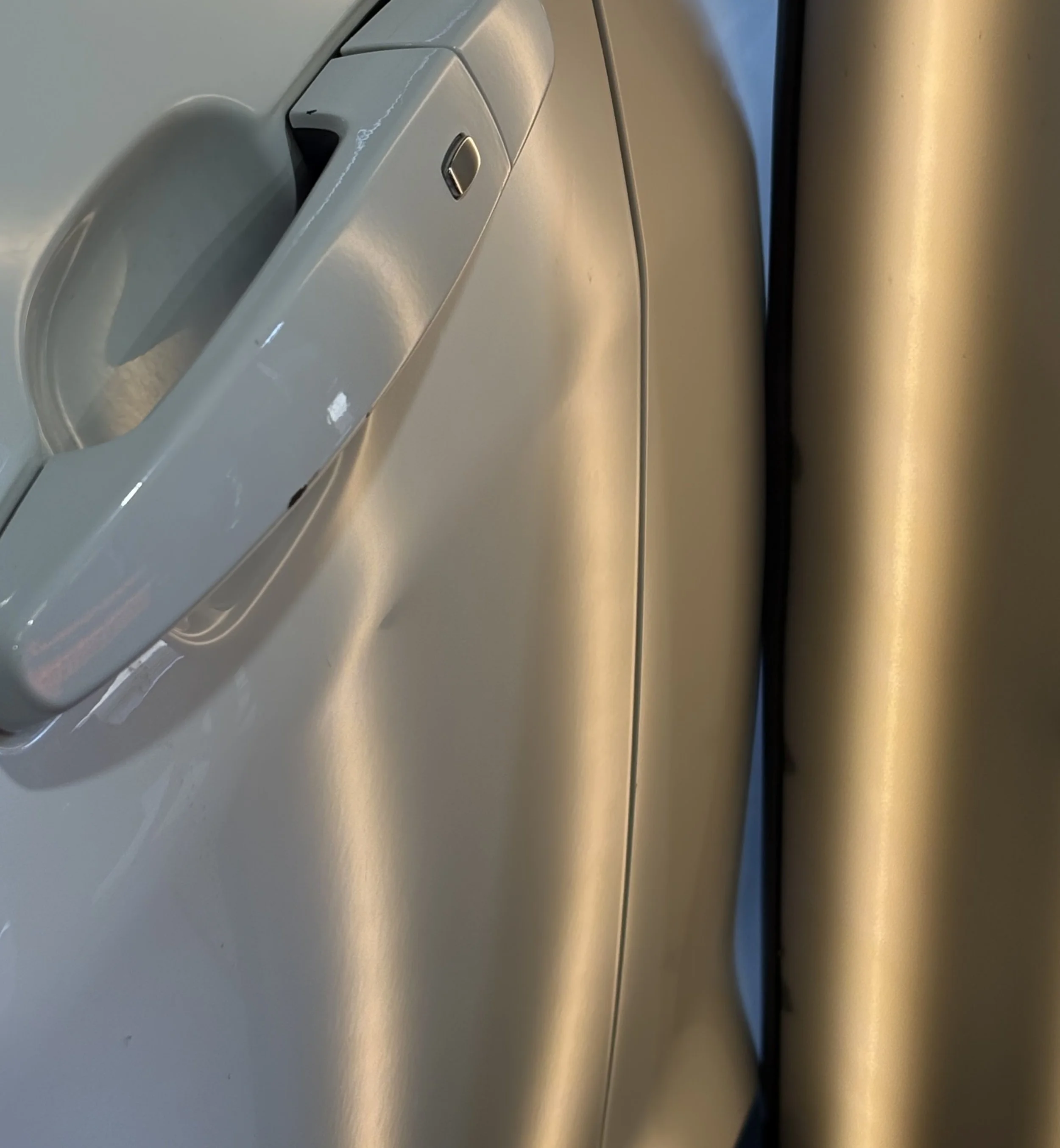 Close-up of a white car door with no dents
