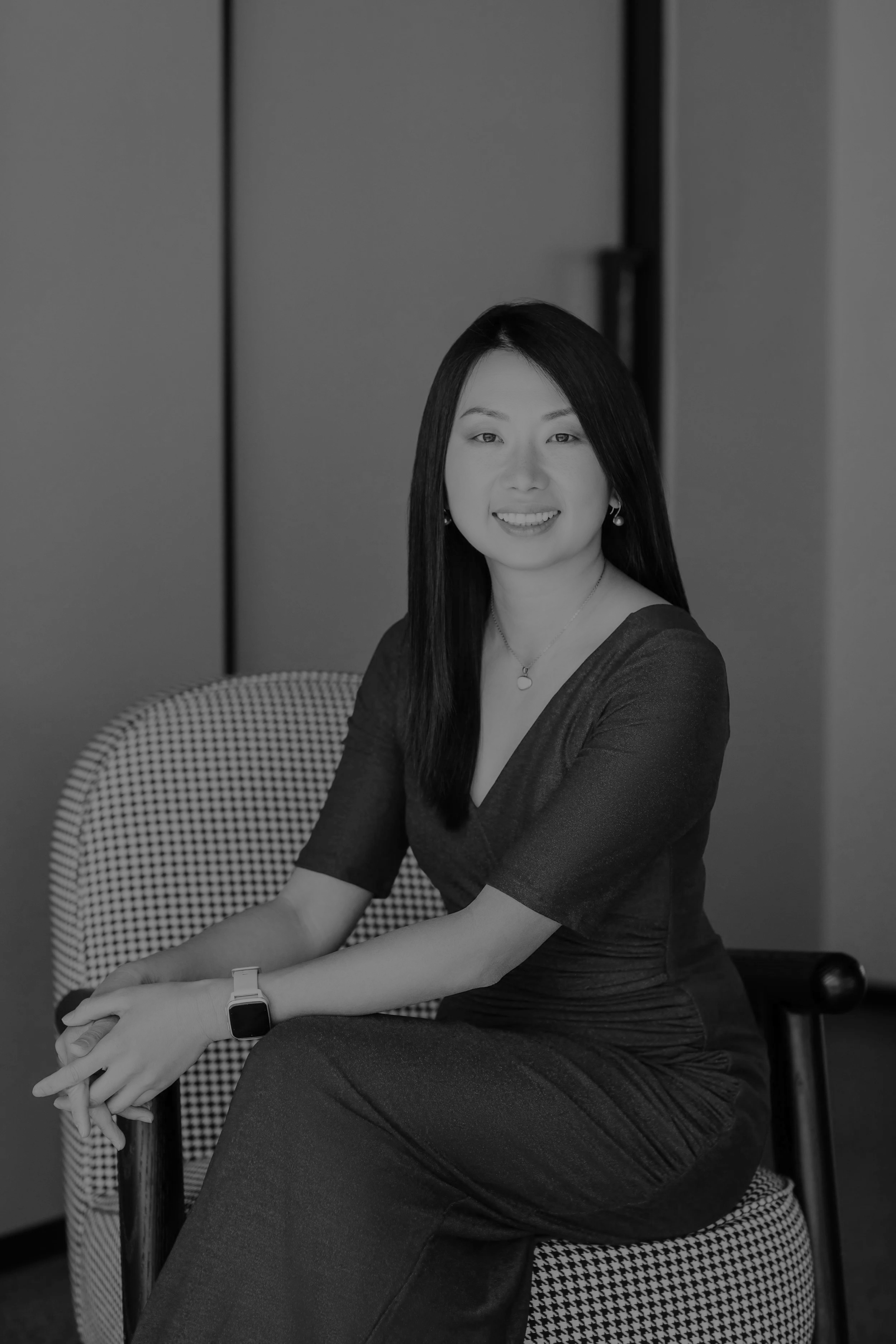 Professional grayscale portrait of Dr. Zen Zeng, elegant musician and educator, seated formally with a warm smile.