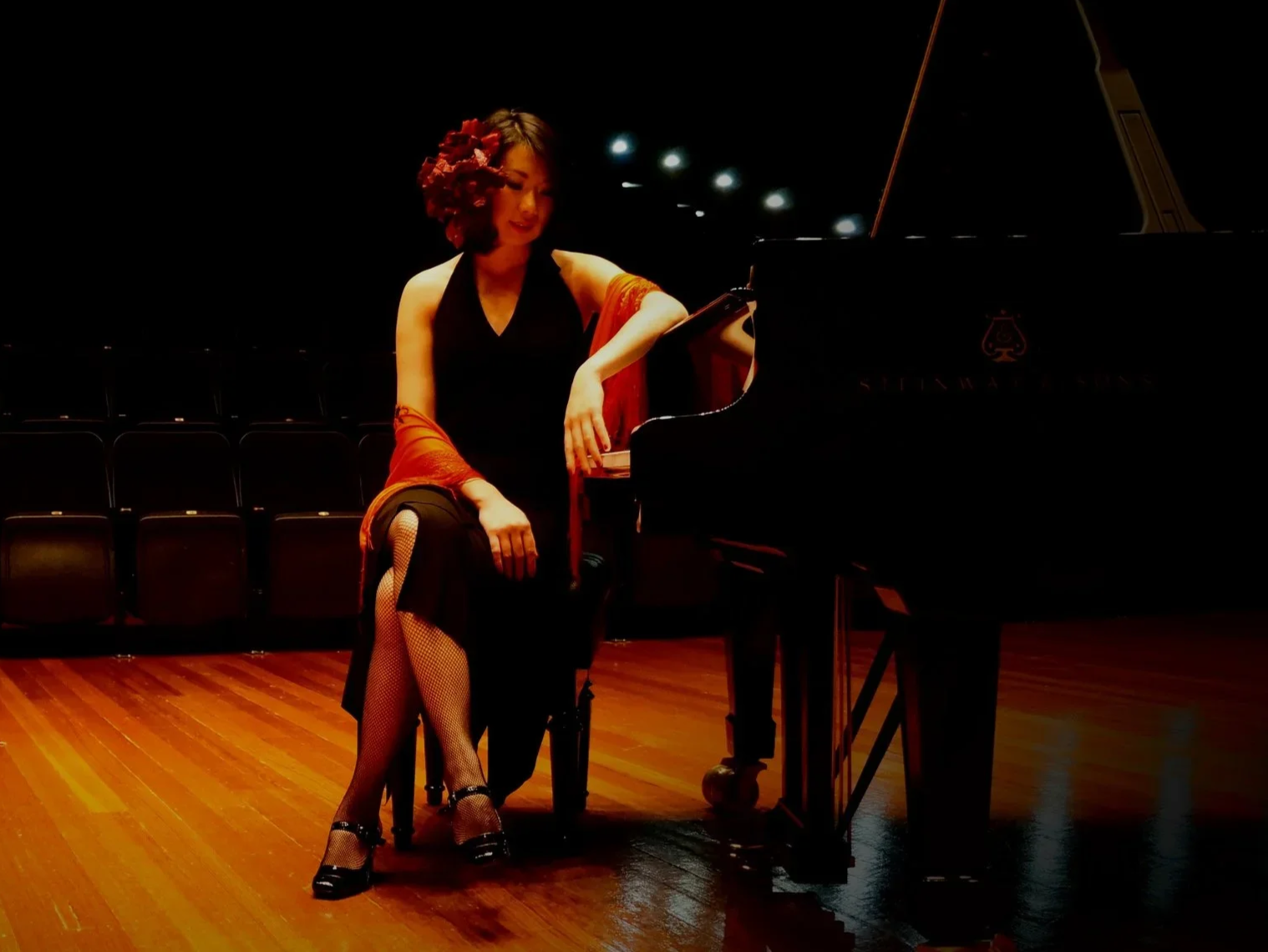Dr. Zen Zeng performing at the grand piano. Founder of Crescendo with Zen.