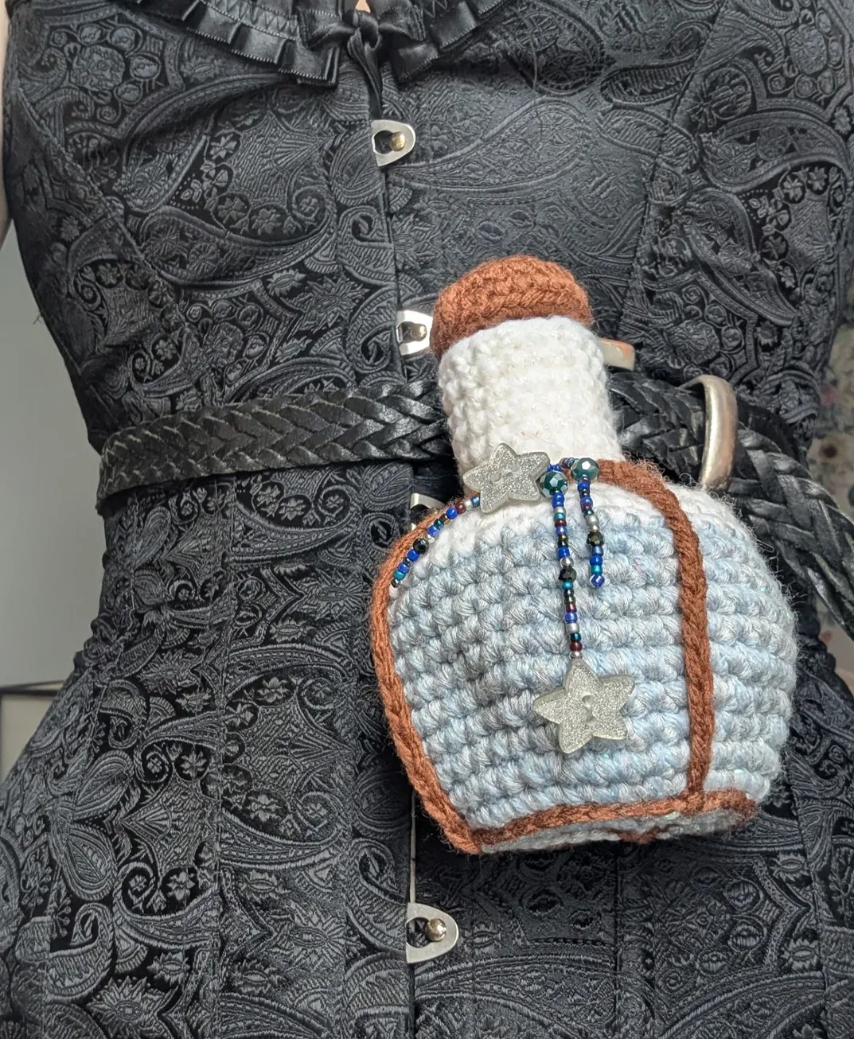 Bottle Star Dust Dice bag with star buttons and bead charms.  
Potion Bottle Pouch Pattern by The Pointed Hat. 
