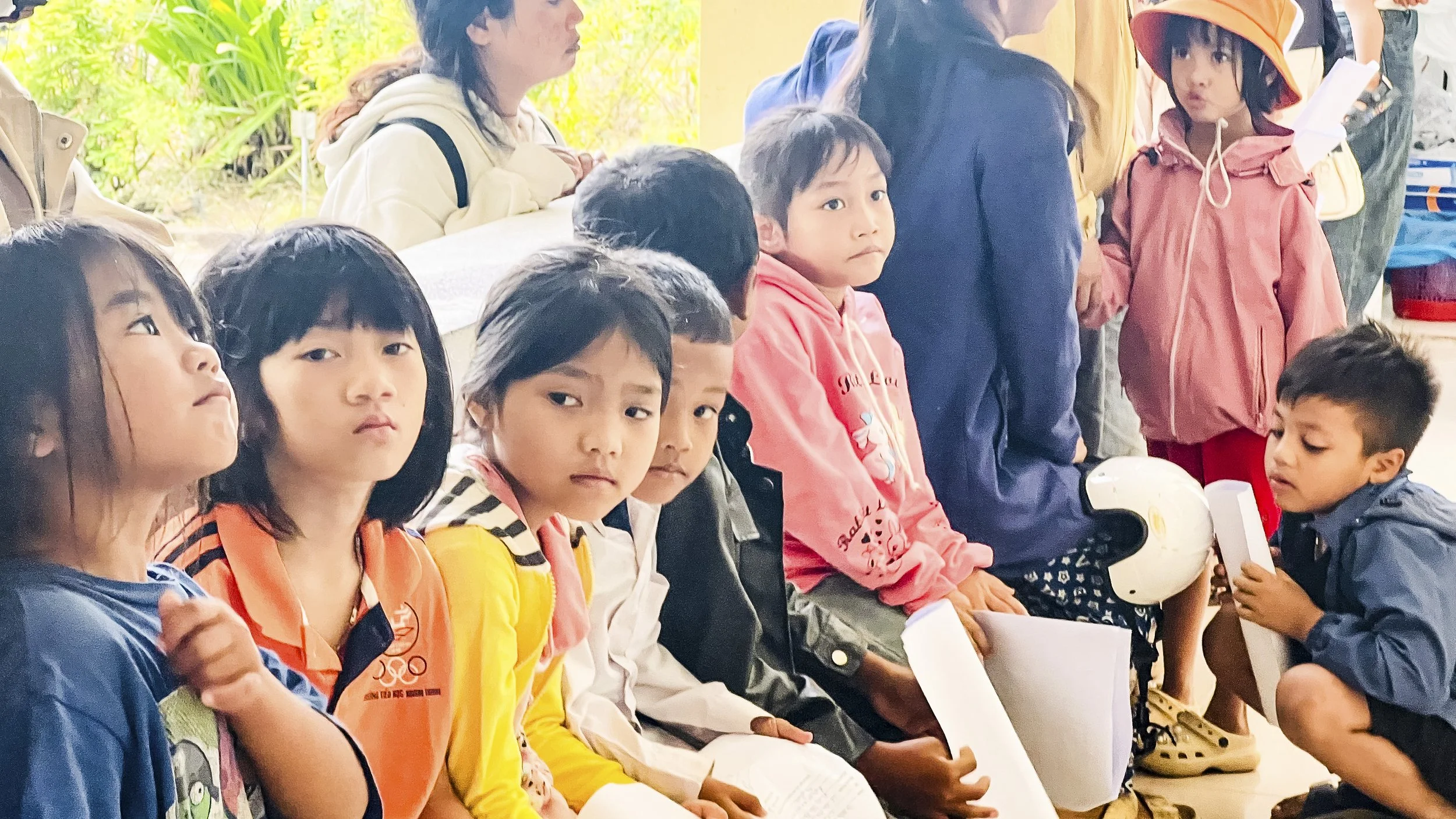 a group of children waiting to be seen by dentists