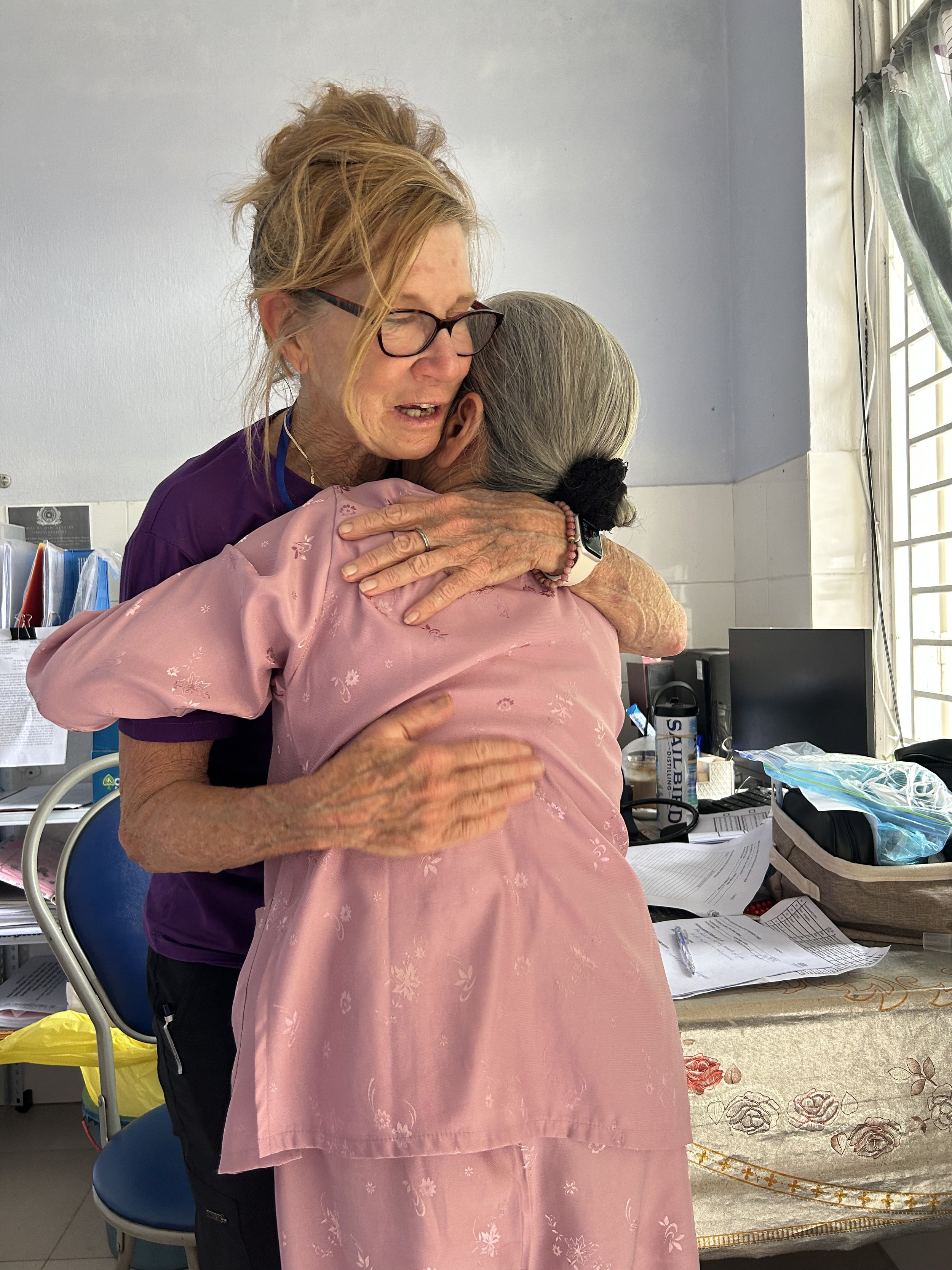 A volunteered nurse hugging a patient showing compassion and care
