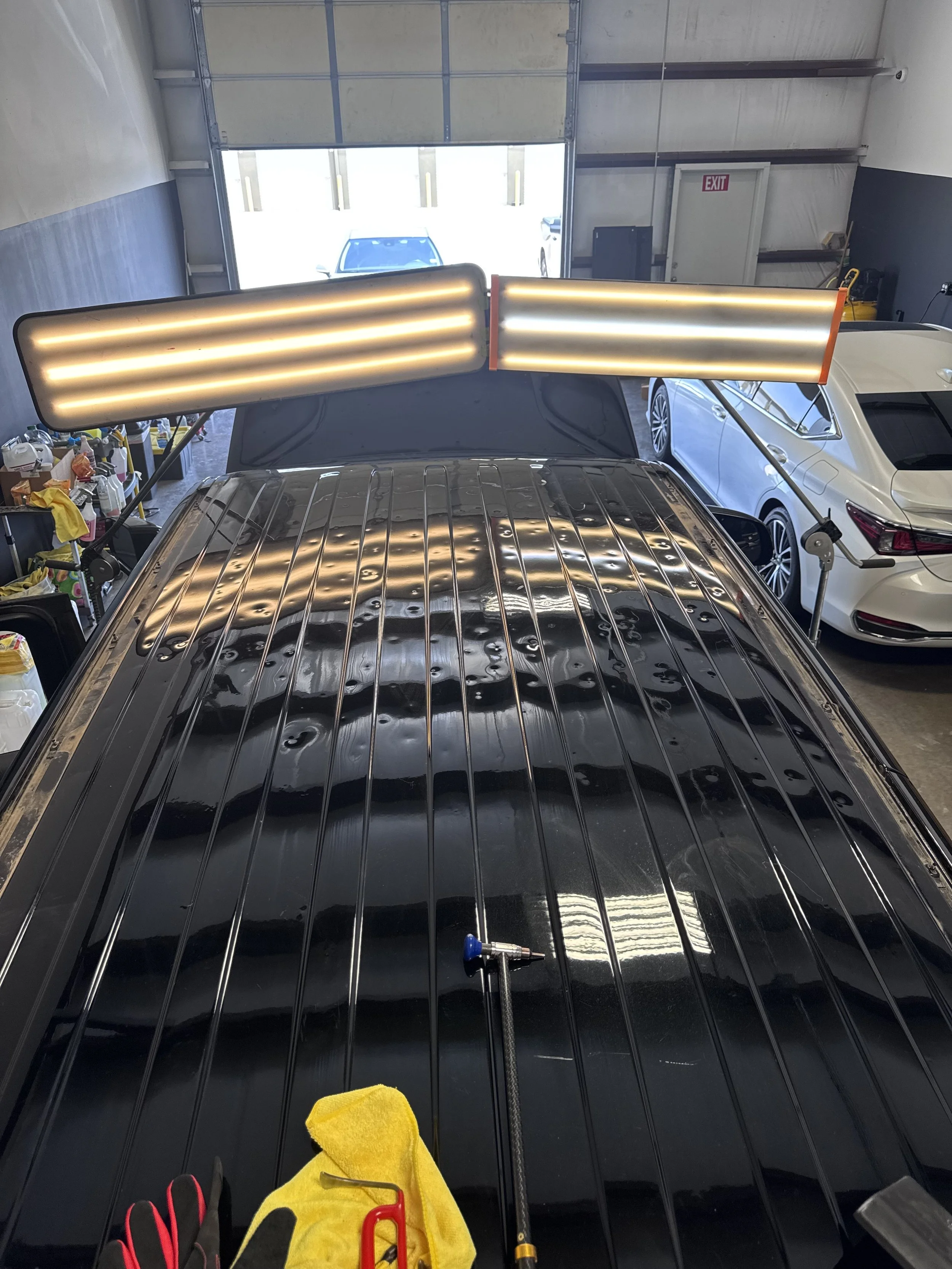 Top of Black SUV with severe hail damage