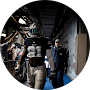 Police officers in tactical gear inside a room with various equipment and a window