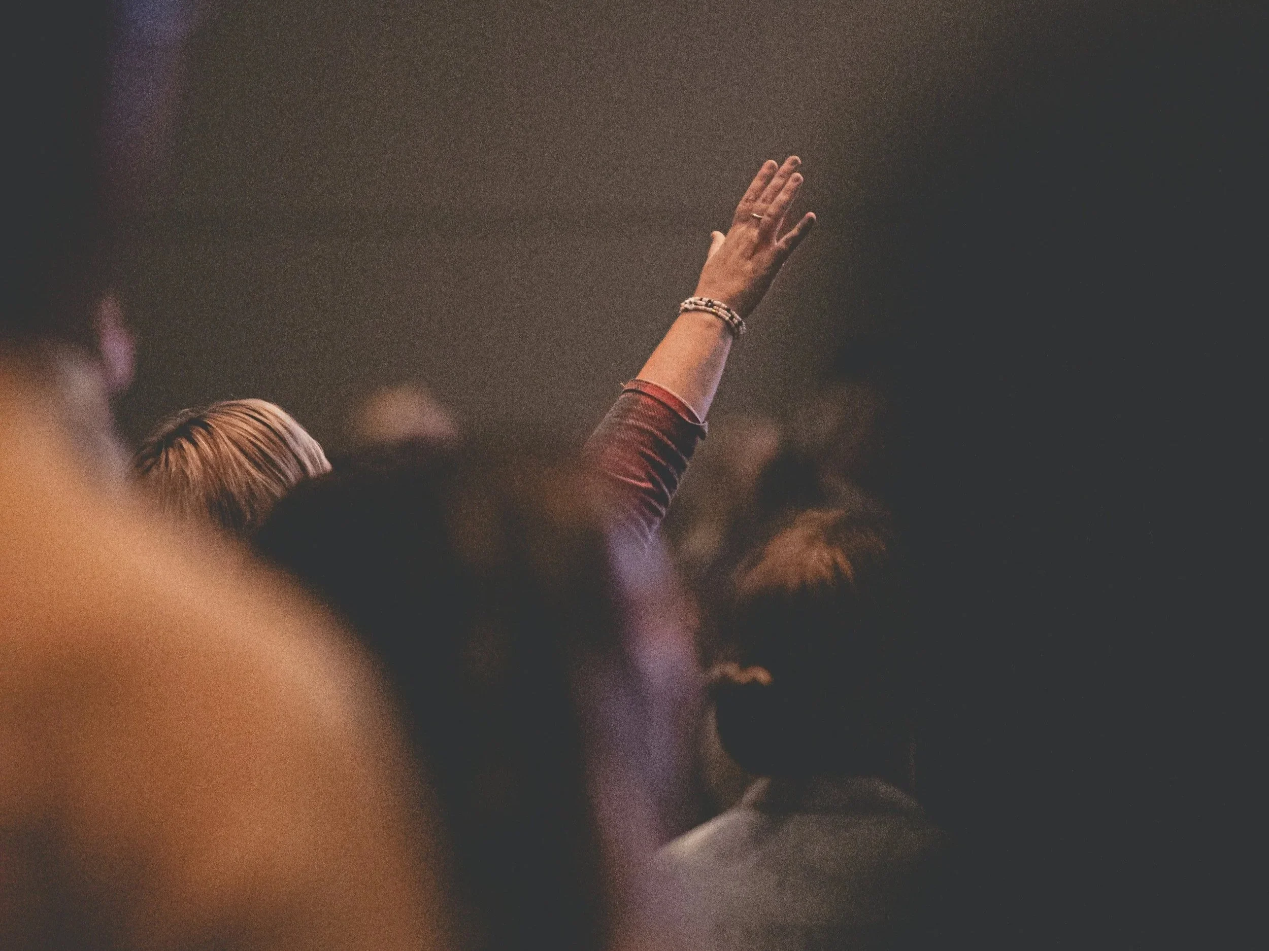 A person raising their hand for worship.