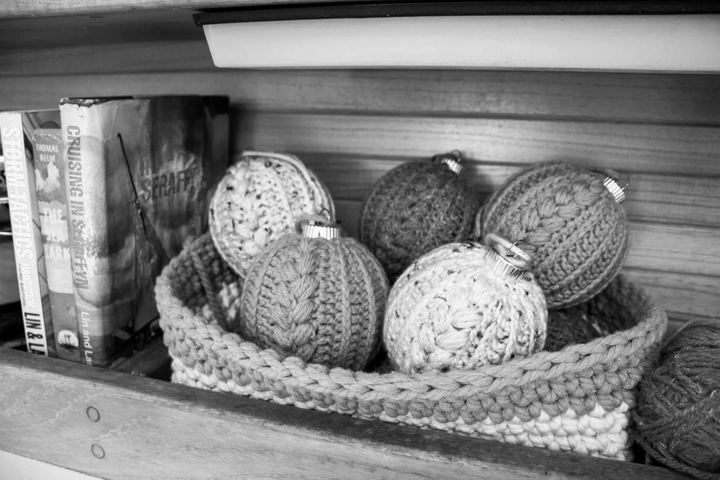 A basket of crochet ornaments in a cruising sailboat galley.