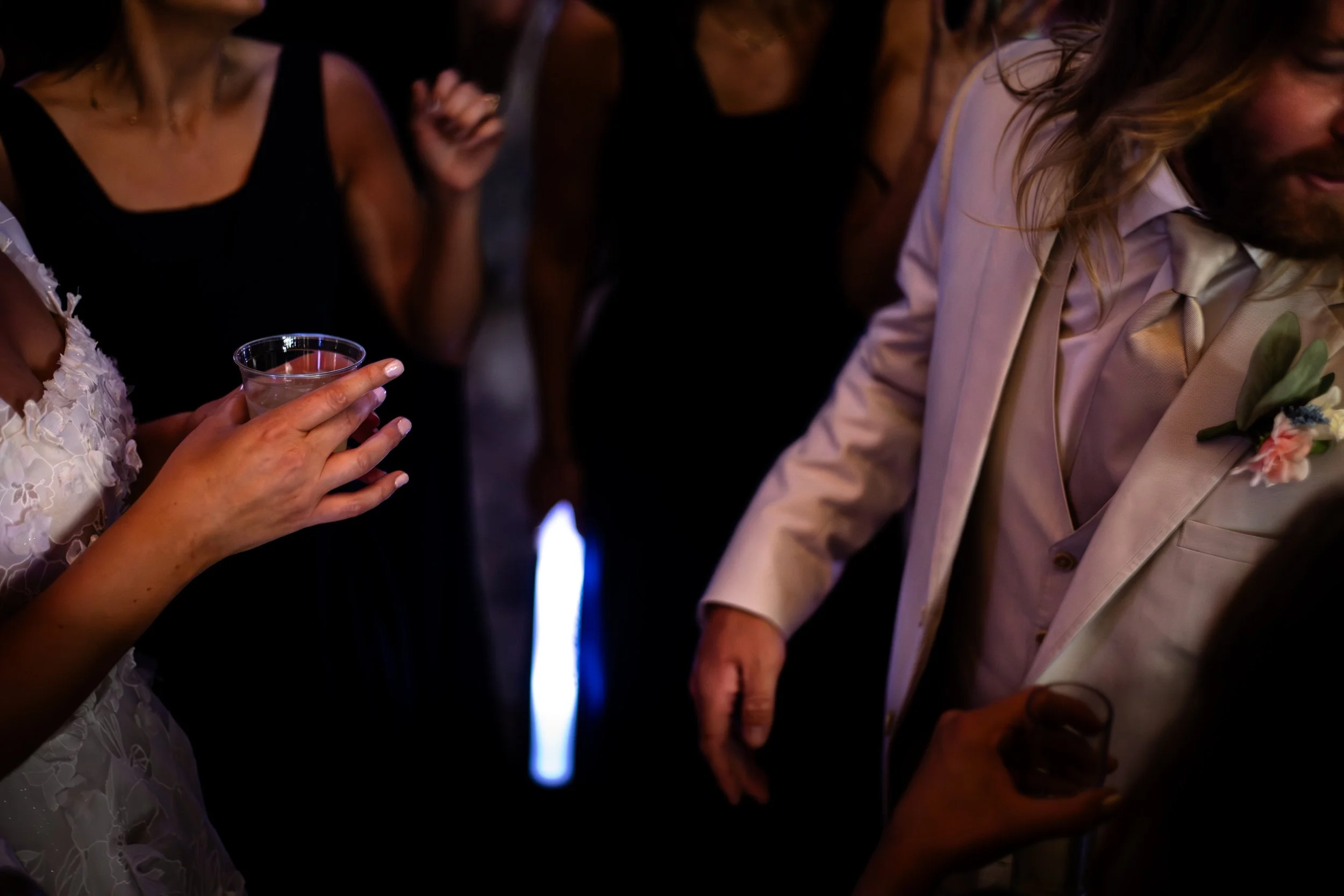 People dressed in formal attire gathered around open flame, possibly during a celebratory event or wedding reception. L'objectif Photography: New Orleans Wedding, Event, and Portrait Photographer
