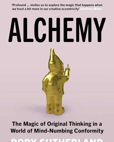 The book cover for 'Alchemy' by Rory Sutherland features a pink background with the title in large black letters. There is a golden gnome statue pointing a finger, positioned centrally. Quotes from Nassim Nicholas Taleb and Geoffrey Miller are at the top, and additional text at the bottom describes the book's theme.