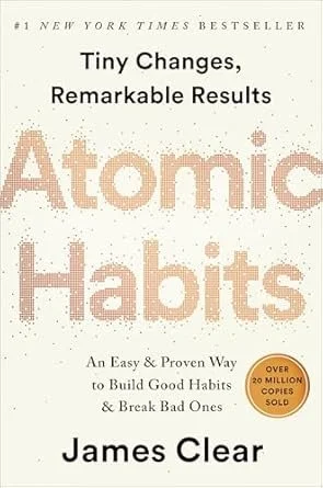 Book cover titled 'Atomic Habits' by James Clear. Subtitle reads 'Tiny Changes, Remarkable Results. An Easy & Proven Way to Build Good Habits & Break Bad Ones.' It has a white background with text in black and beige, and a gold sticker noting 'Over 20 Million Copies Sold.'