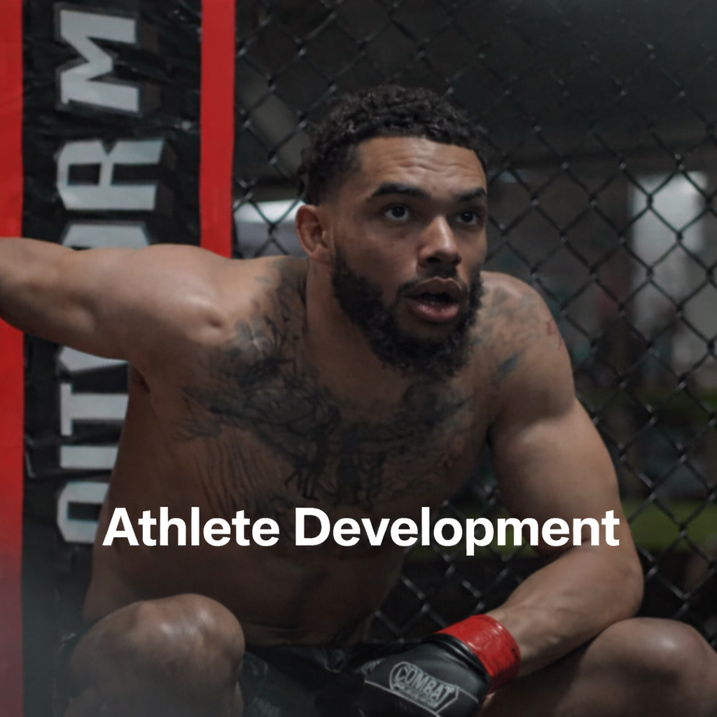 A male athlete with tattoos on his chest and arm, wearing red and black gloves, in a fighting stance inside a cage, with the words 'Athlete Development' overlaid.