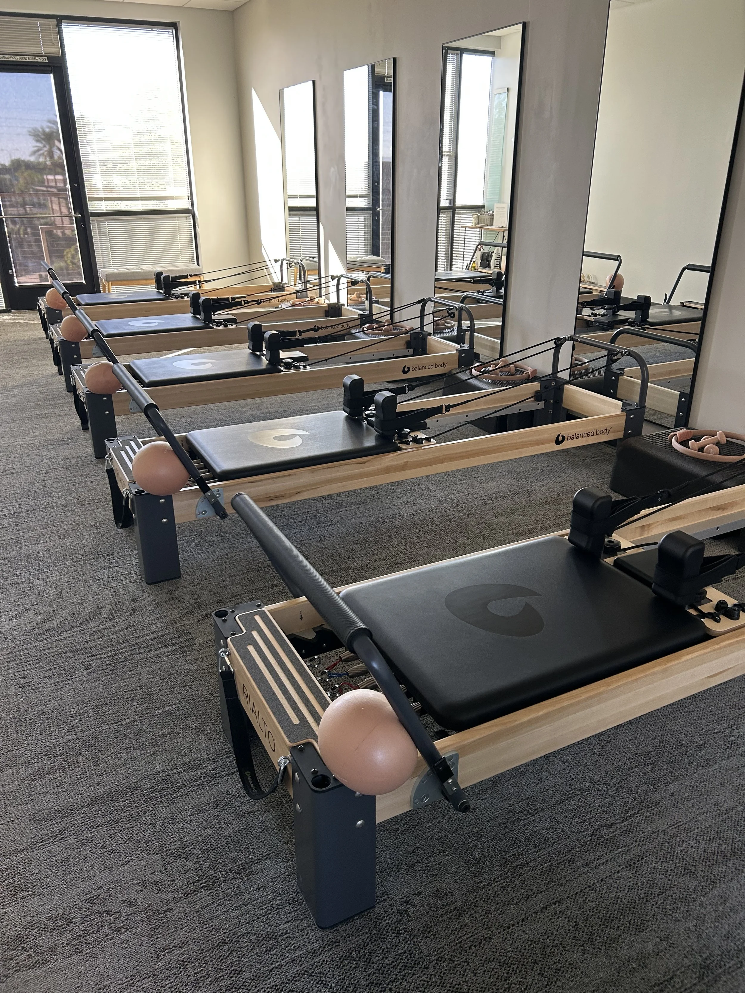 Row of Reformer Pilates machines