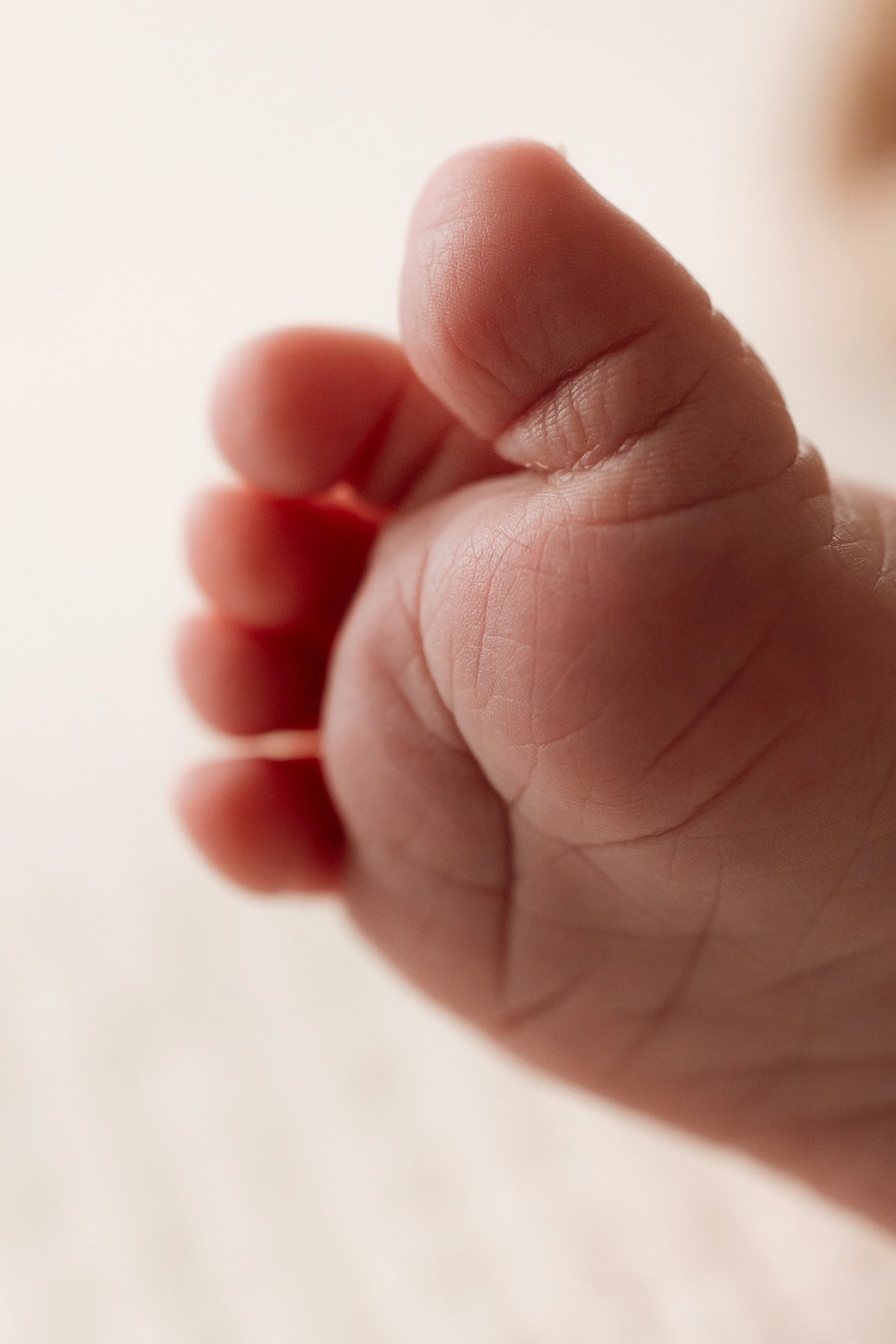 Close-up of a person's hand with fingers curled inward.