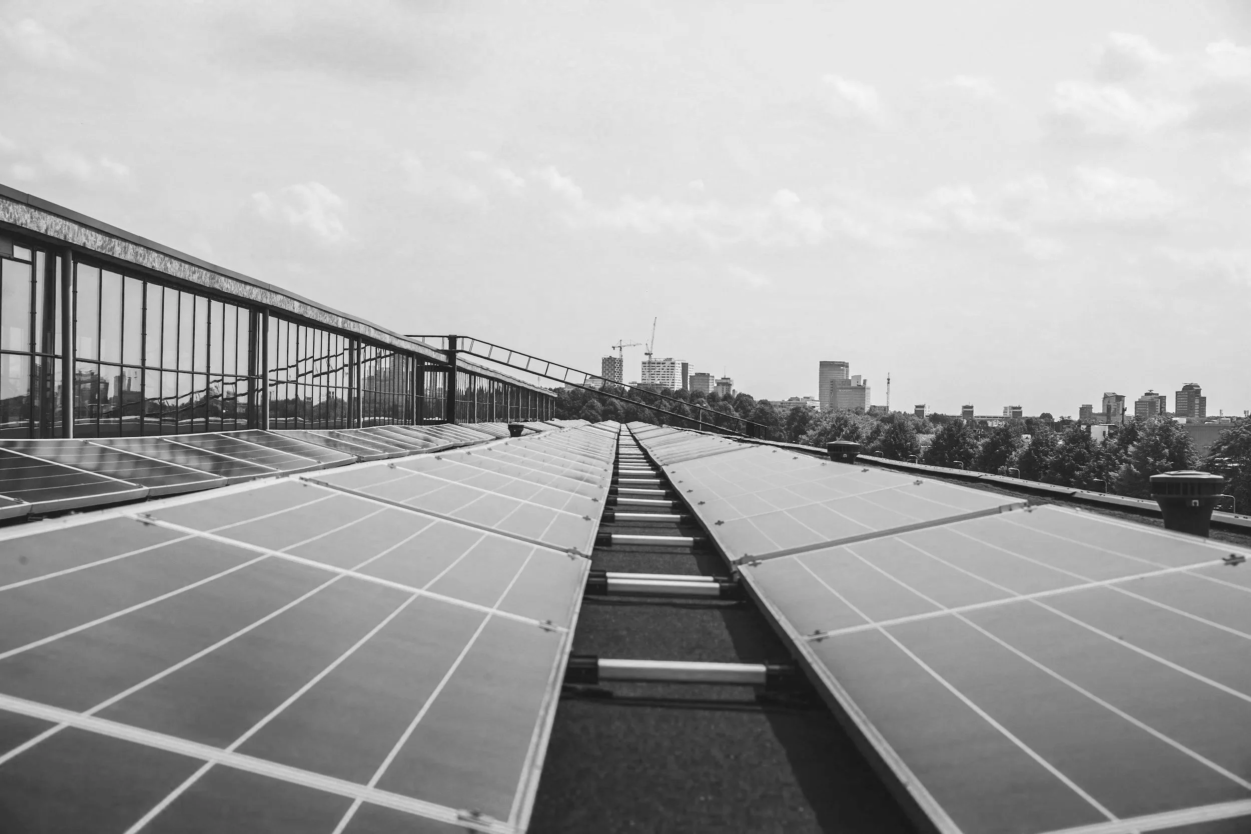 photovoltaic systems on an industrial roof with a cityscape in the background