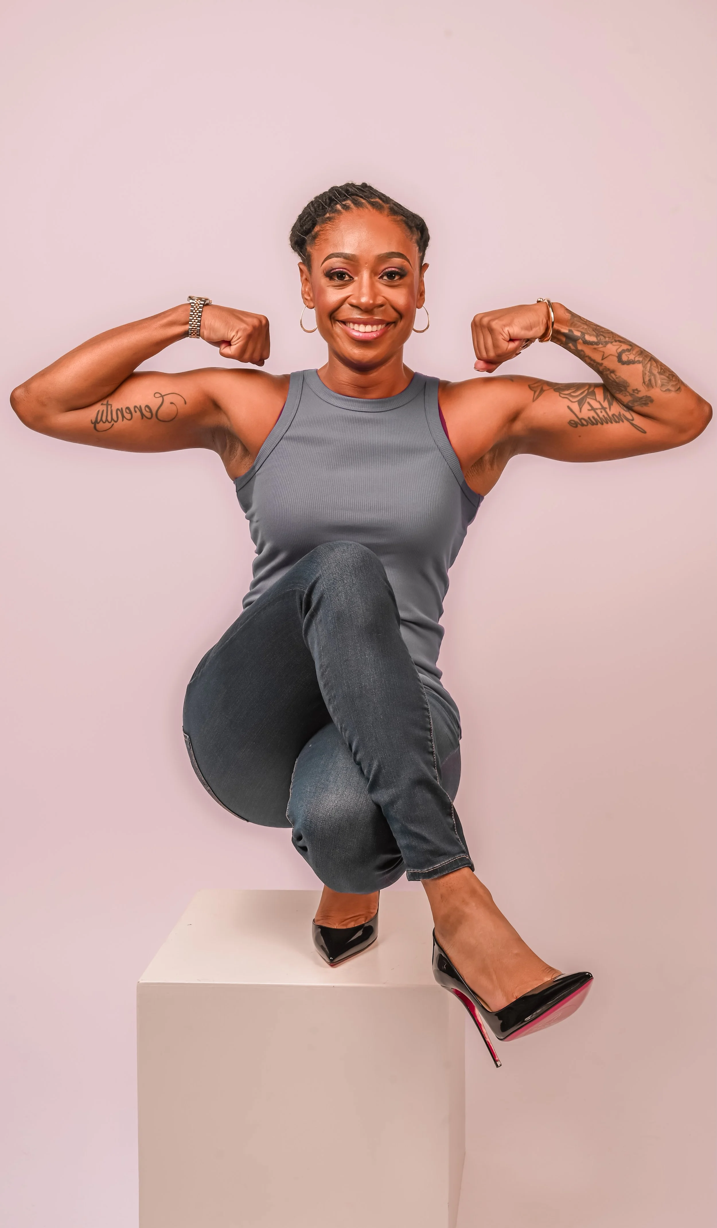 Rashida Saunders posing confidently with arms flexed in a studio setting.