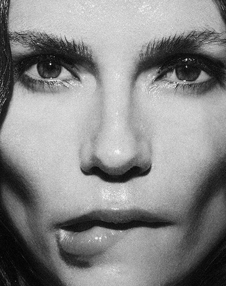 Close-up black and white photo of a woman's face showing her eyes, nose, and lips.